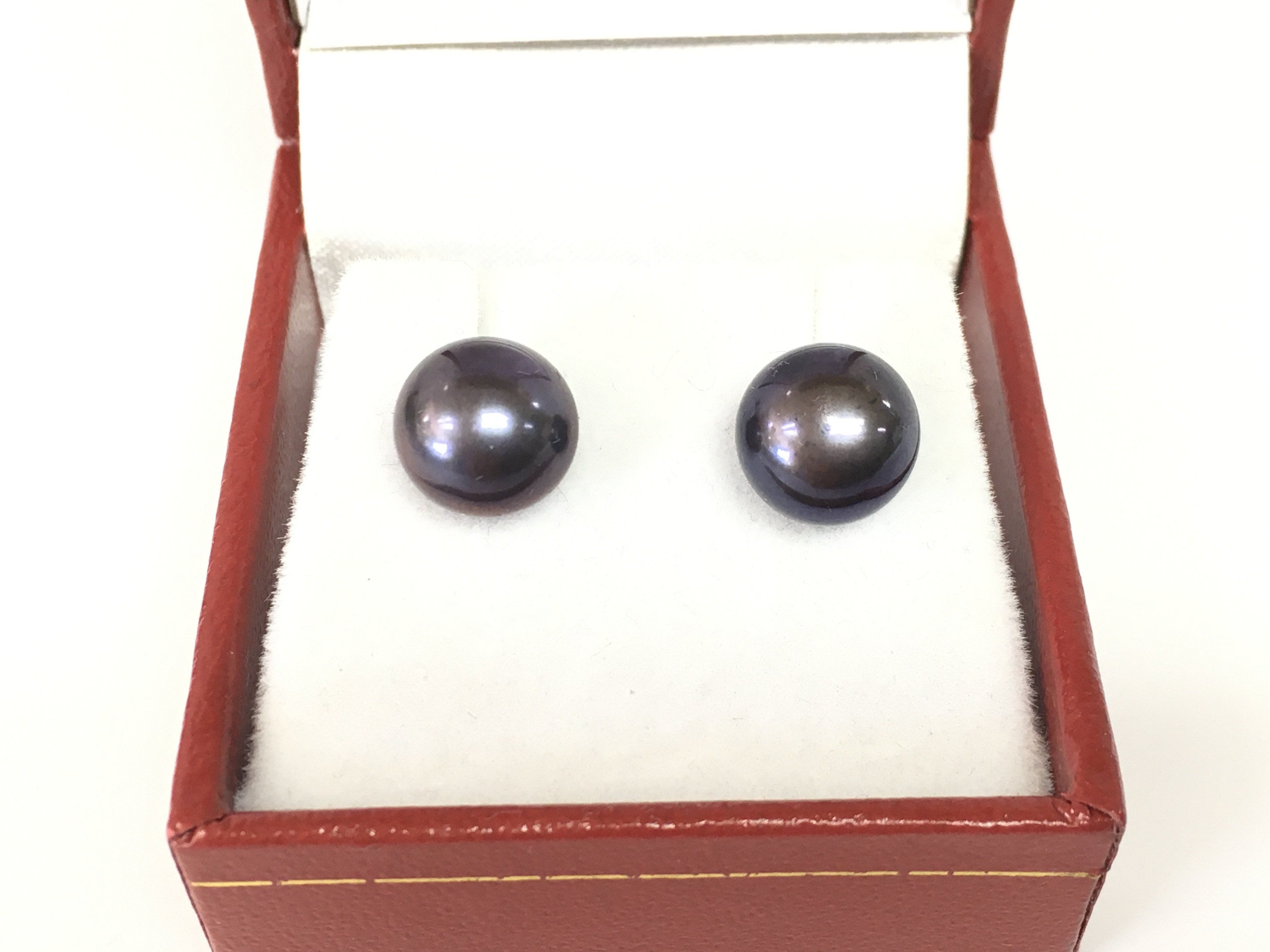 A pair of 9ct yellow gold oblate spheroid purple blue green cultured pearl studs. Postage B