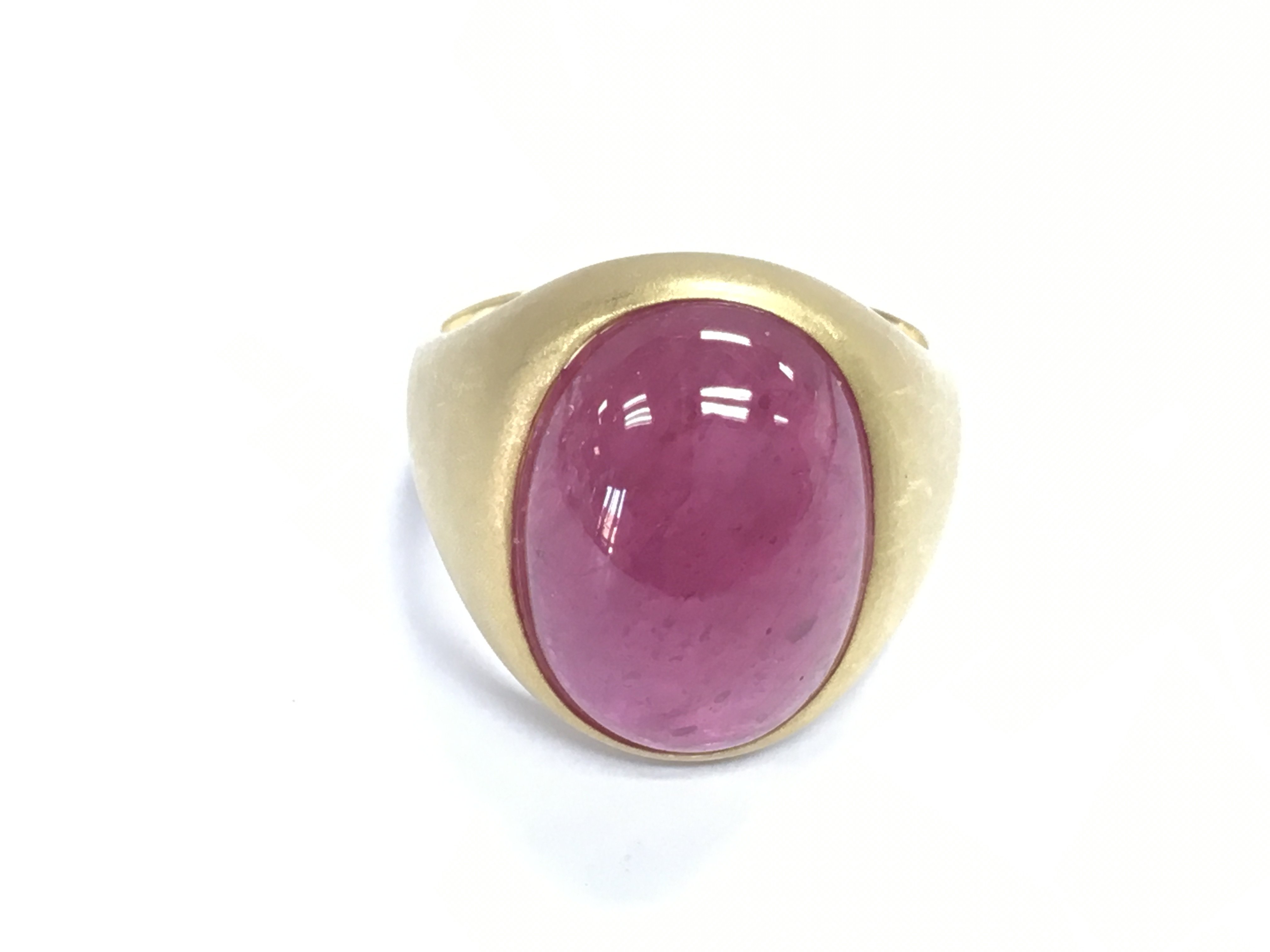 18ct yellow gold ring with satin and polished finish set with large oval cabochon ruby and glass gemstone 27ct. Size V 1/2. Comes with gemological report.