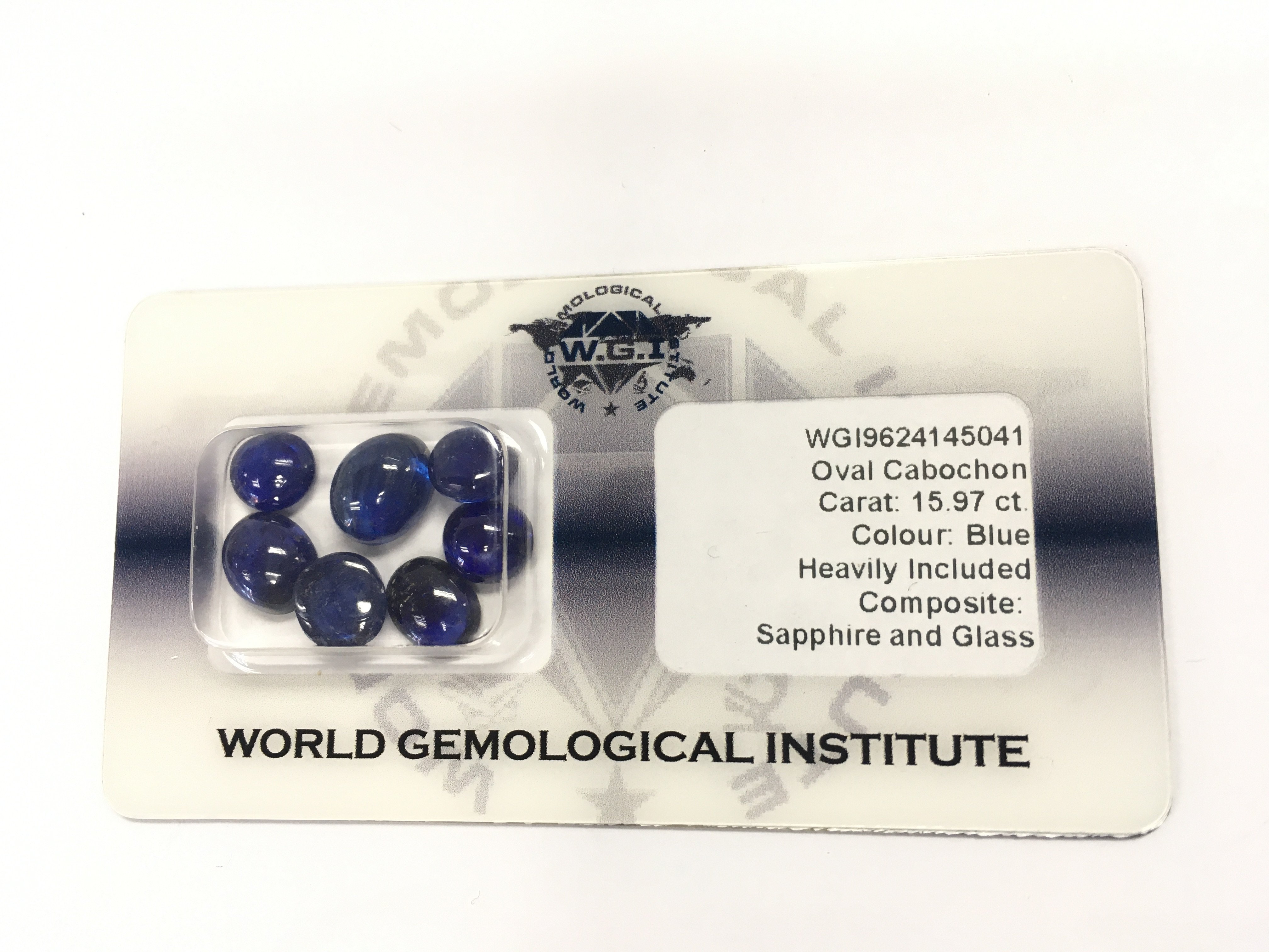 A certified security sealed parcel of 7 cabochon glass filled sapphire totalling 15.97ct. Postage B