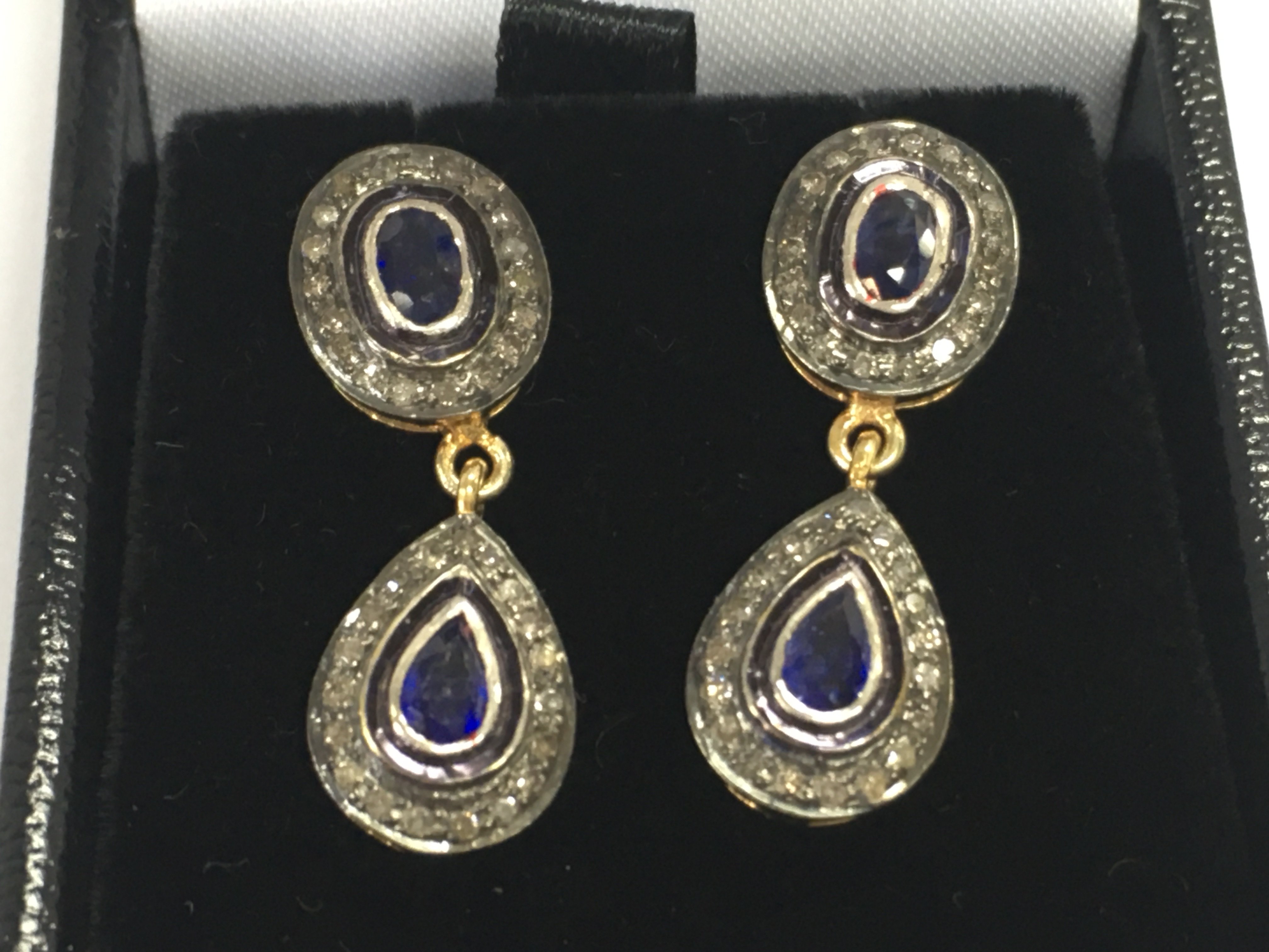 A pair of double drop earring set with pear shaped and oval sapphires each surrounded by RC diamond in gold plated silver. Approximately 0.75vt sapphire and 0.48ct diamonds. Postage B