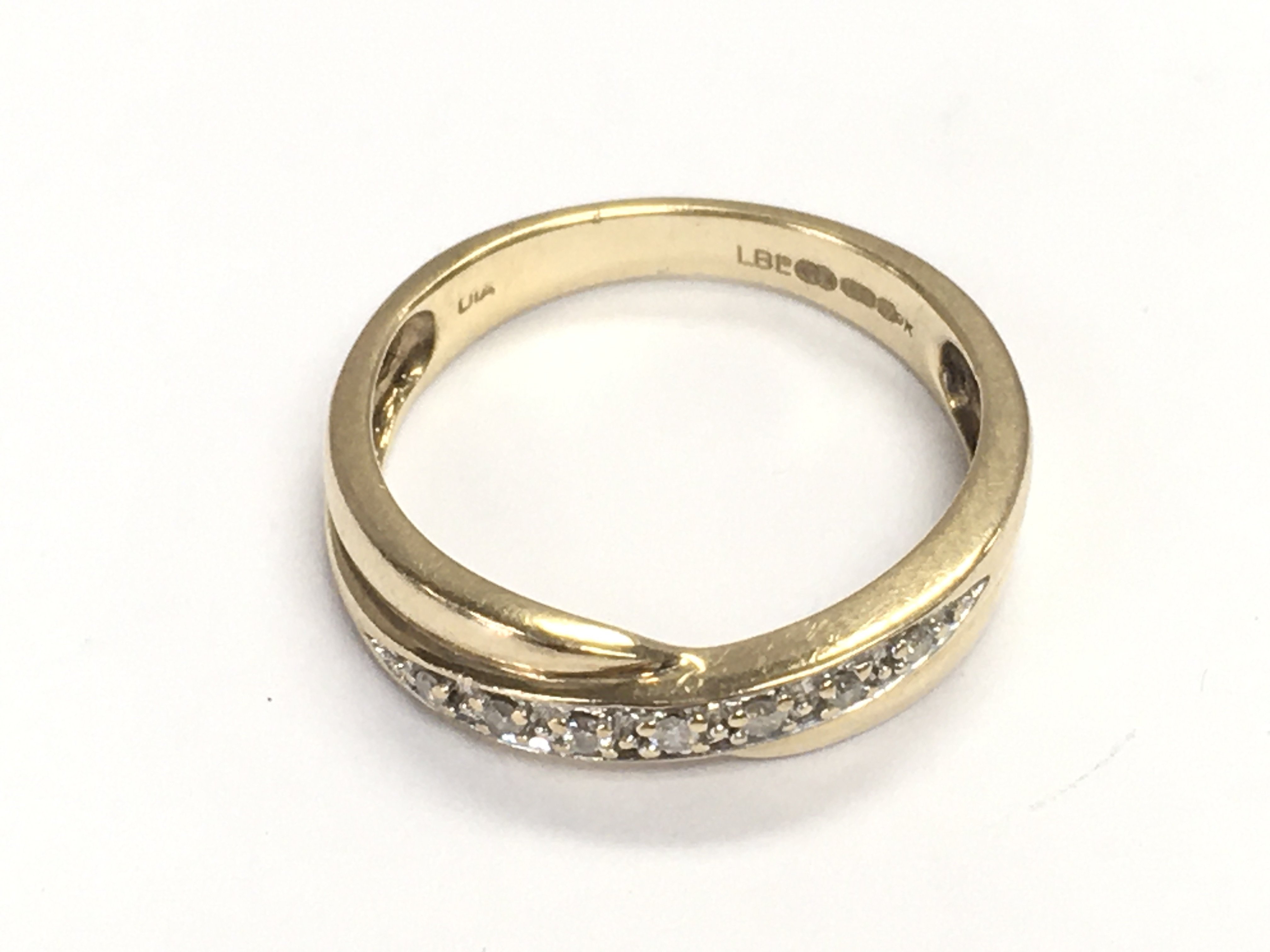 A 9ct yellow gold twist ring set with RC diamonds Approx 0.10ct. Size M and 2.39g Postage A