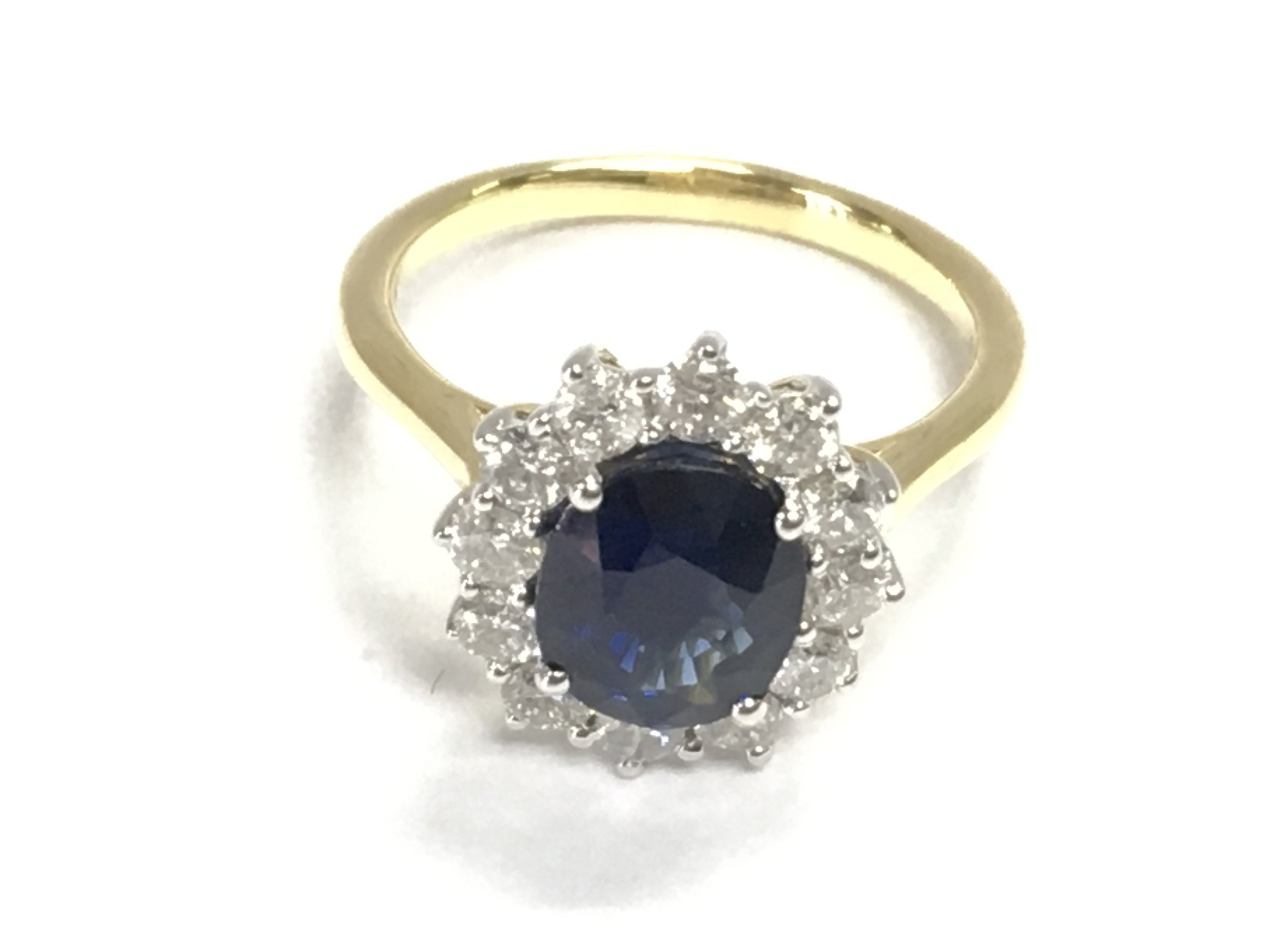 An 18ct yellow and white gold oval sapphire and RBC diamond cluster ring. Sapphire&#2013266057۪s 3.03ct and 0.84ct size N