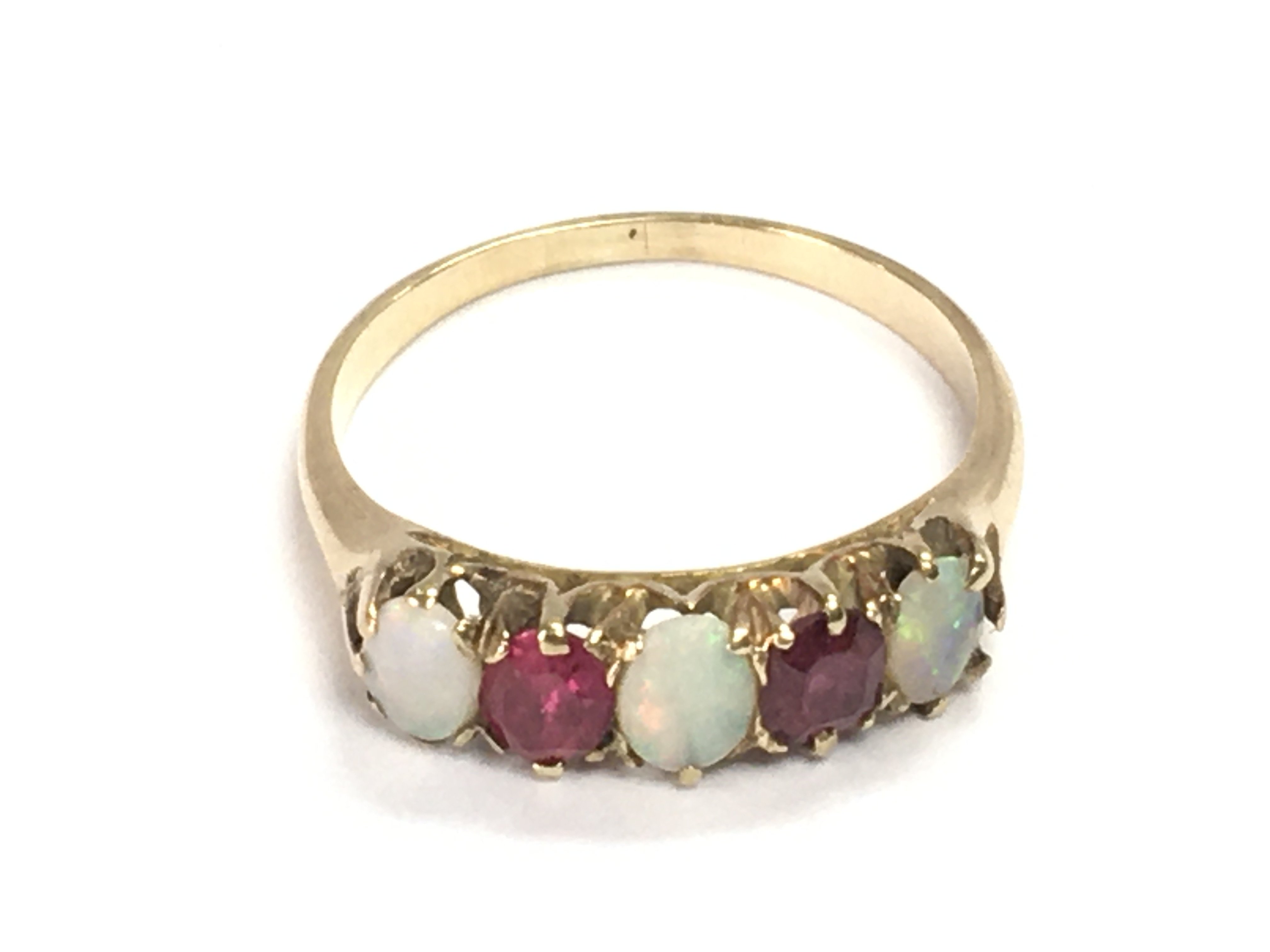 An unmarked ruby and opal ring size P 1/2 and 2.92g Postage A