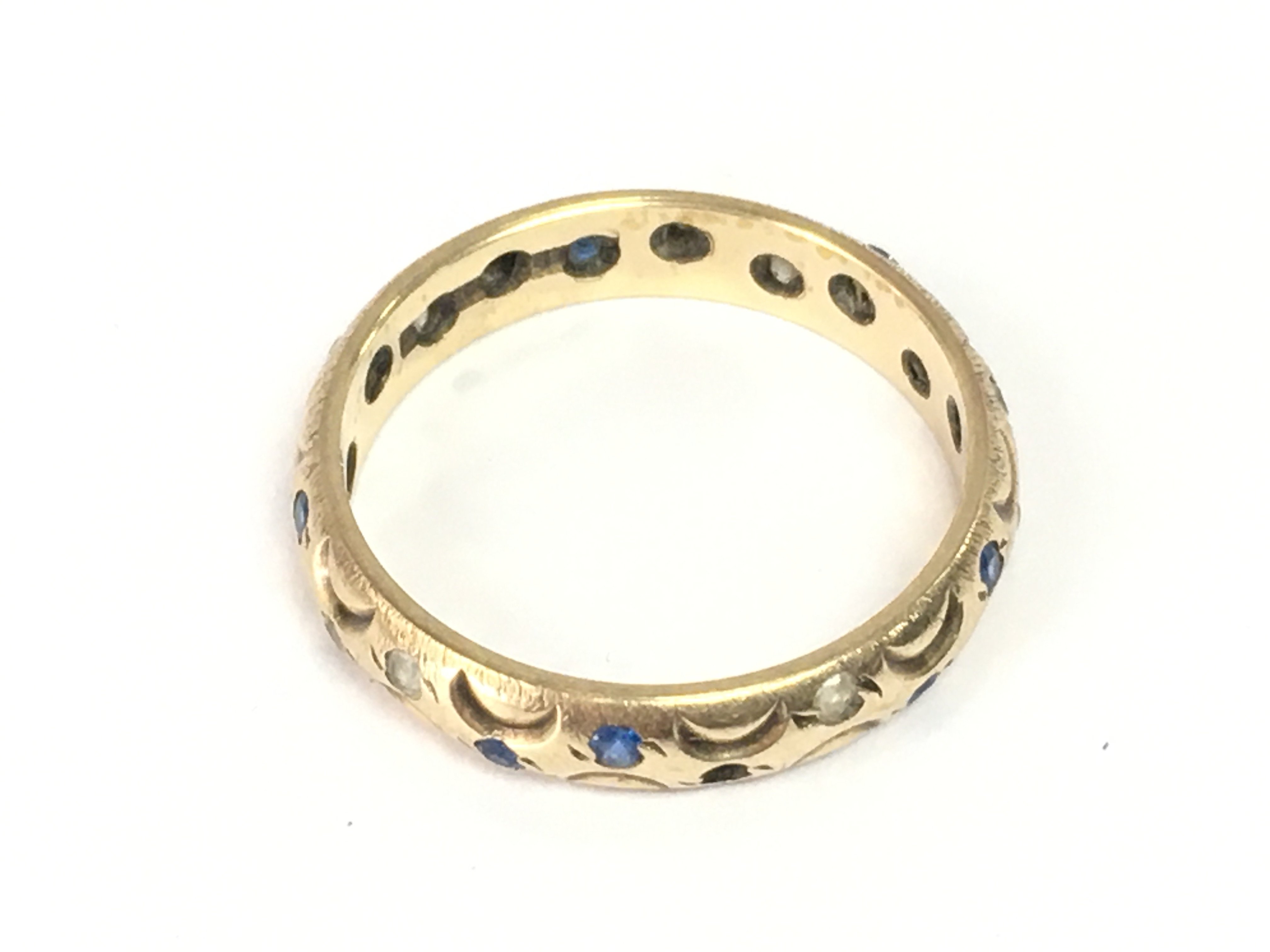 A 9ct gold ring set with a row of chip stones. Size N and 2.65g