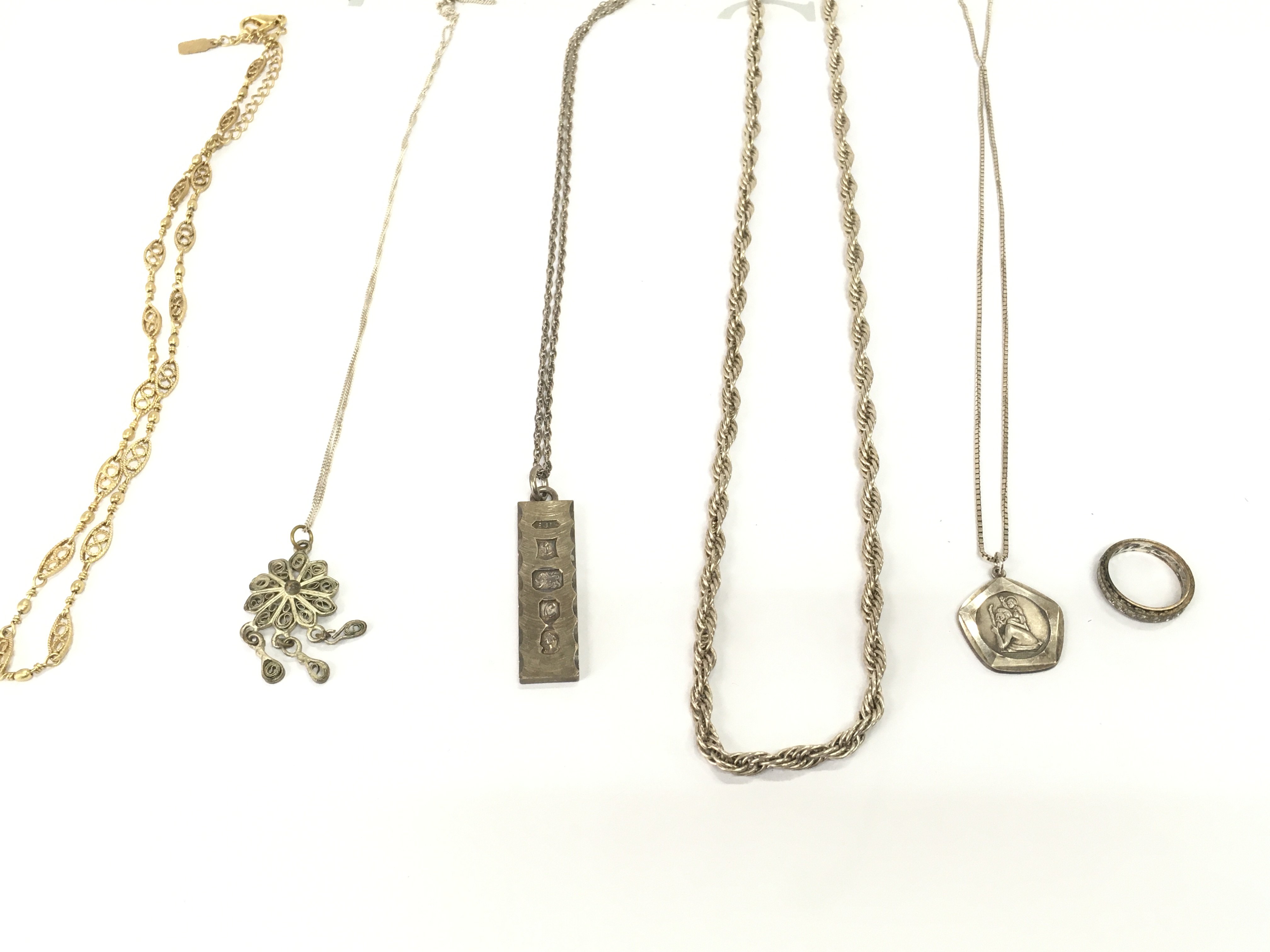 Collection of silver chains and other including a silver ingot on necklace. Postage B