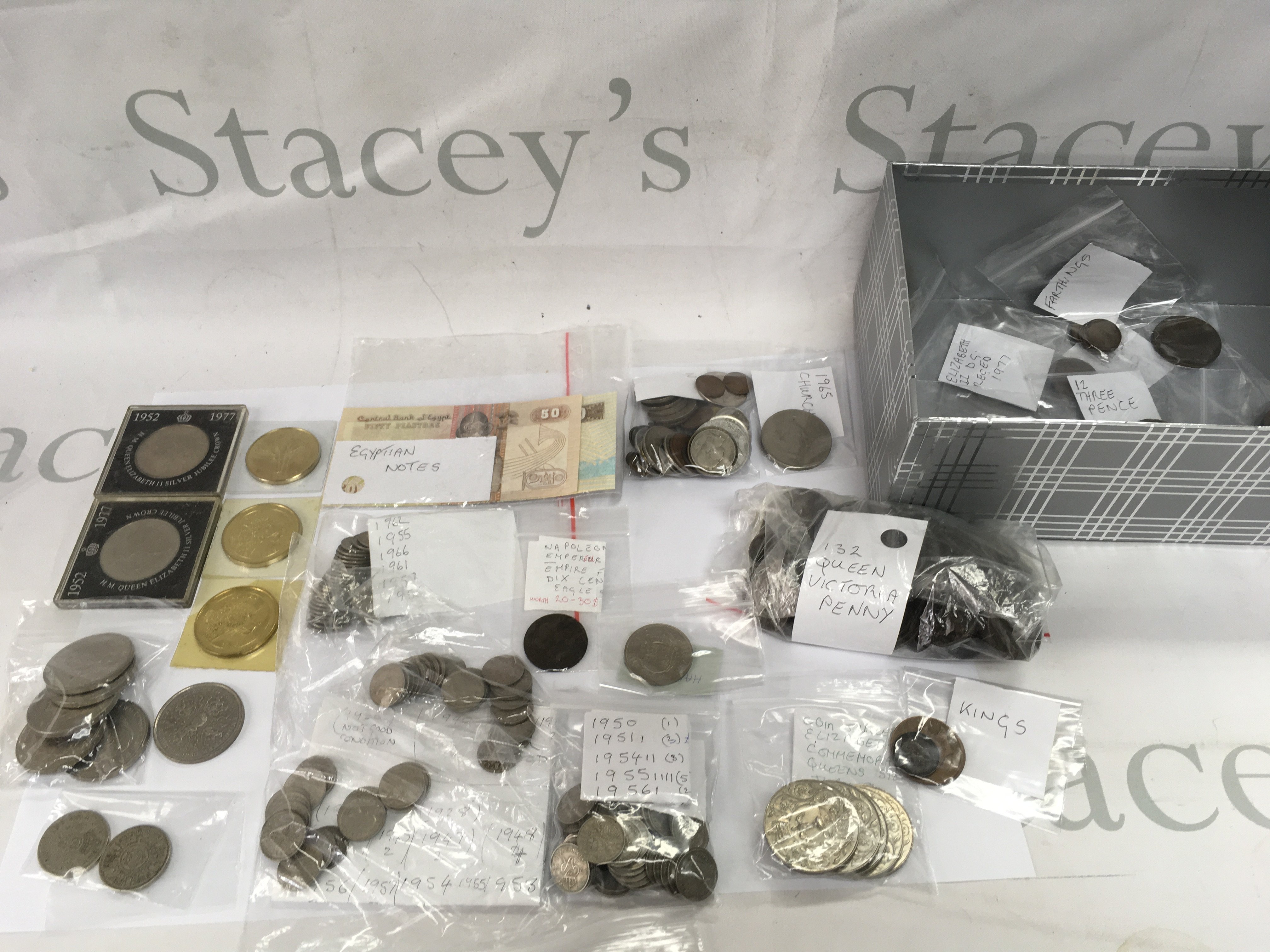 A box containing assorted used circulated coinage and some commemorative packs.