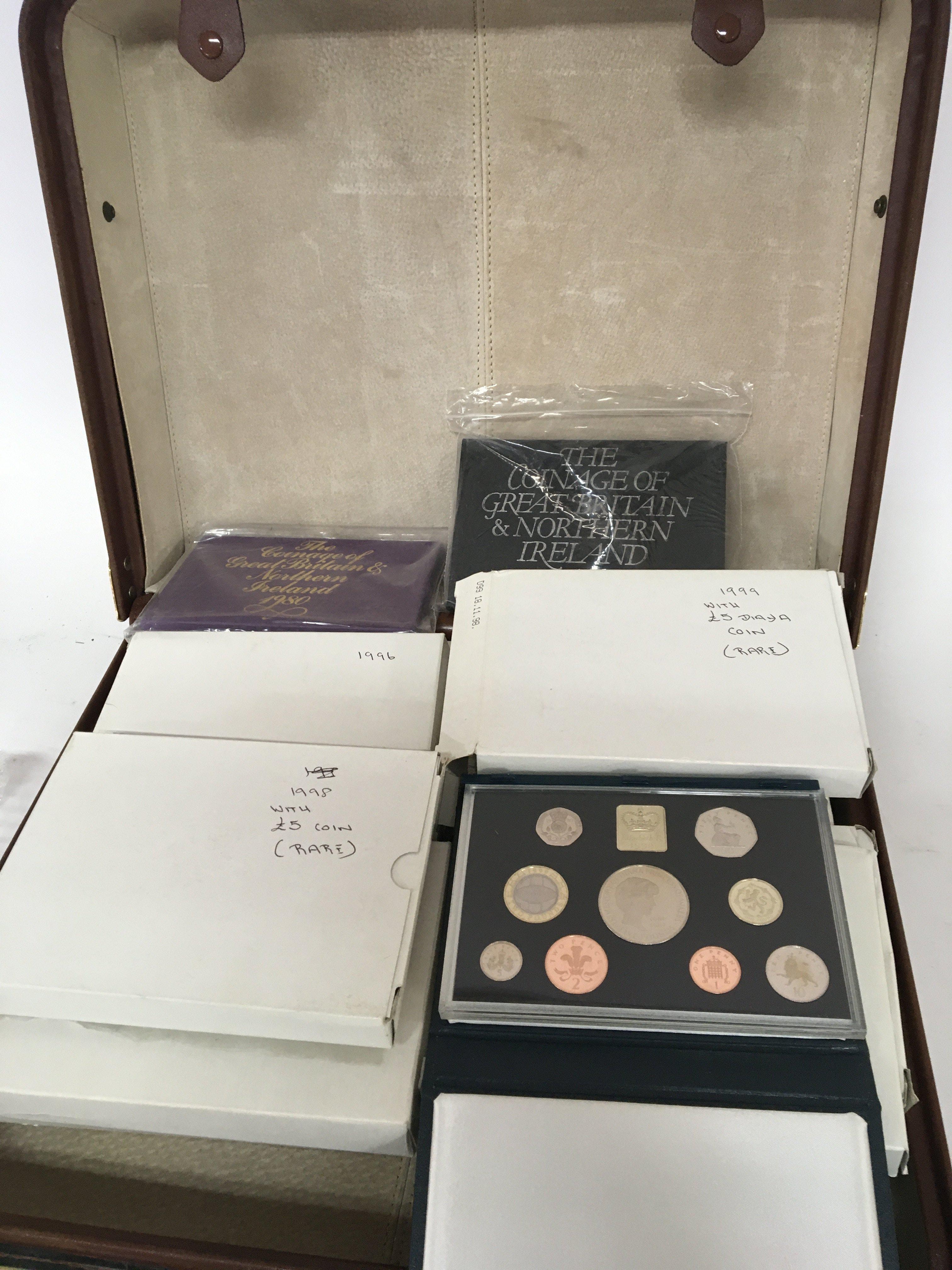 A leather case containing approximately 27 collection of proof annual decimal sets from 1970-1990 with some doubles and other coinage including silver 1977 crown and others, including &#20132660835.00 sets