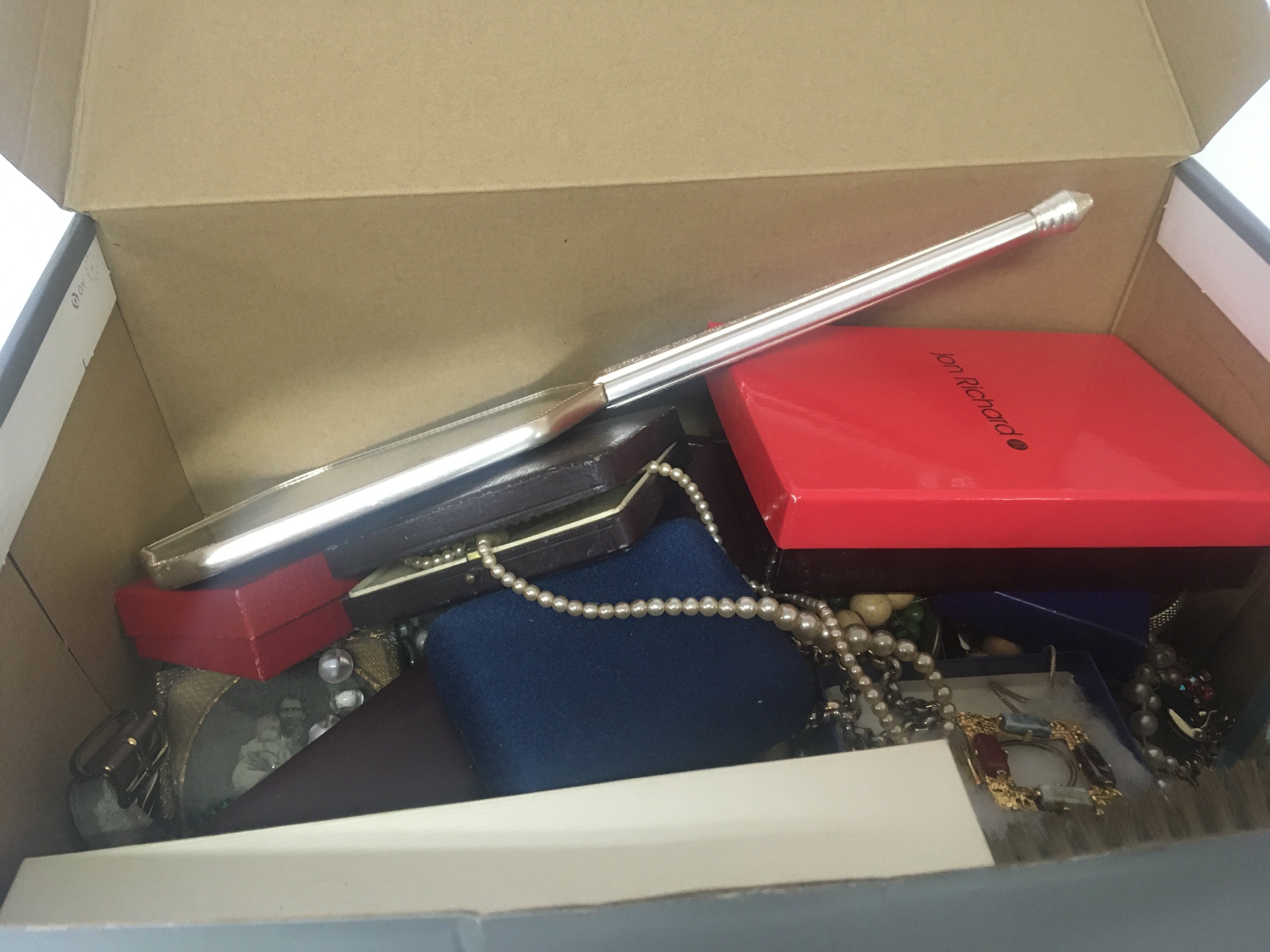 A box containing a collection of costume jewellery and oddments watches.