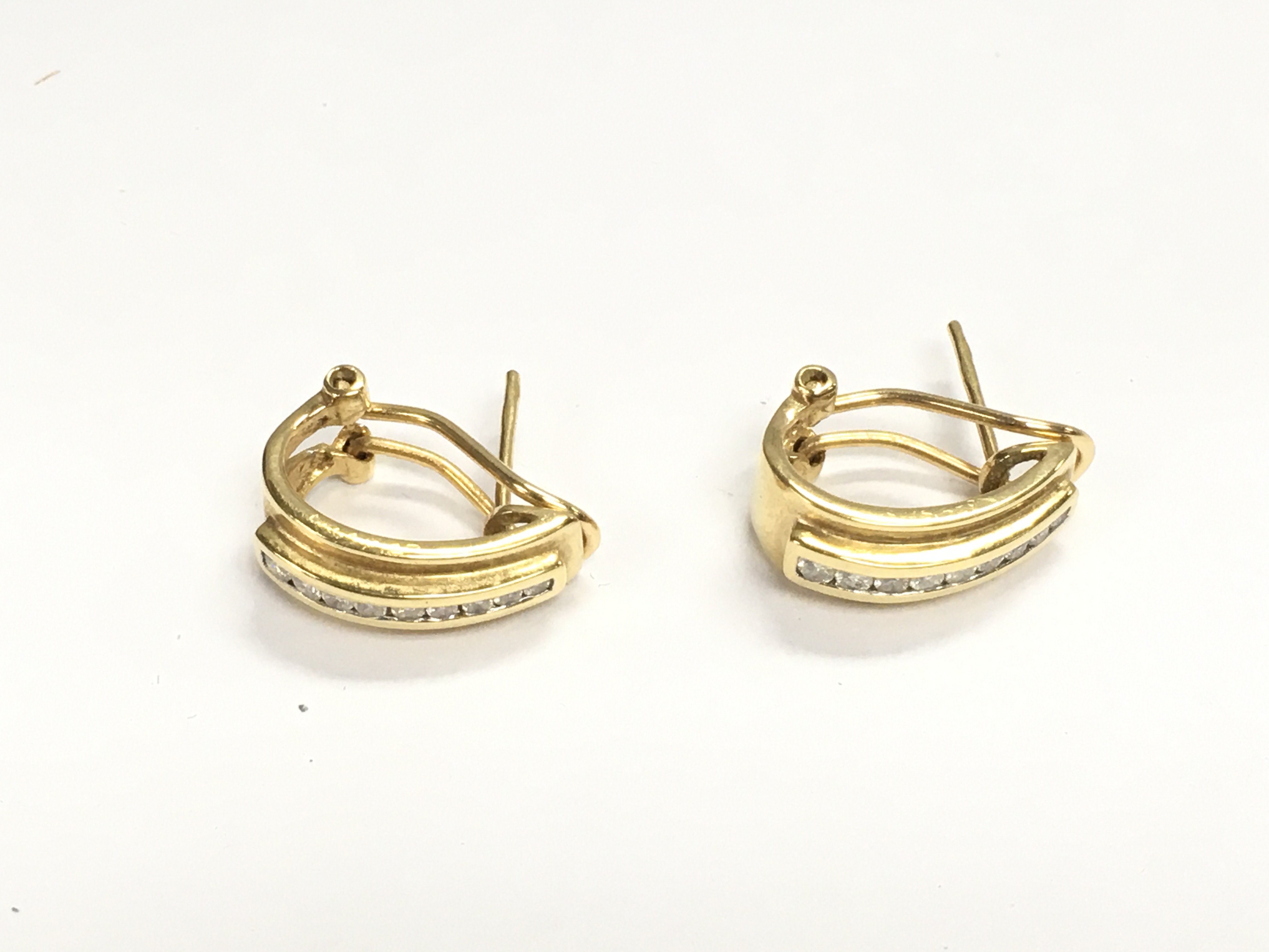 A pair of 18ct gold and diamond clip / stud earrings. 4.12g
