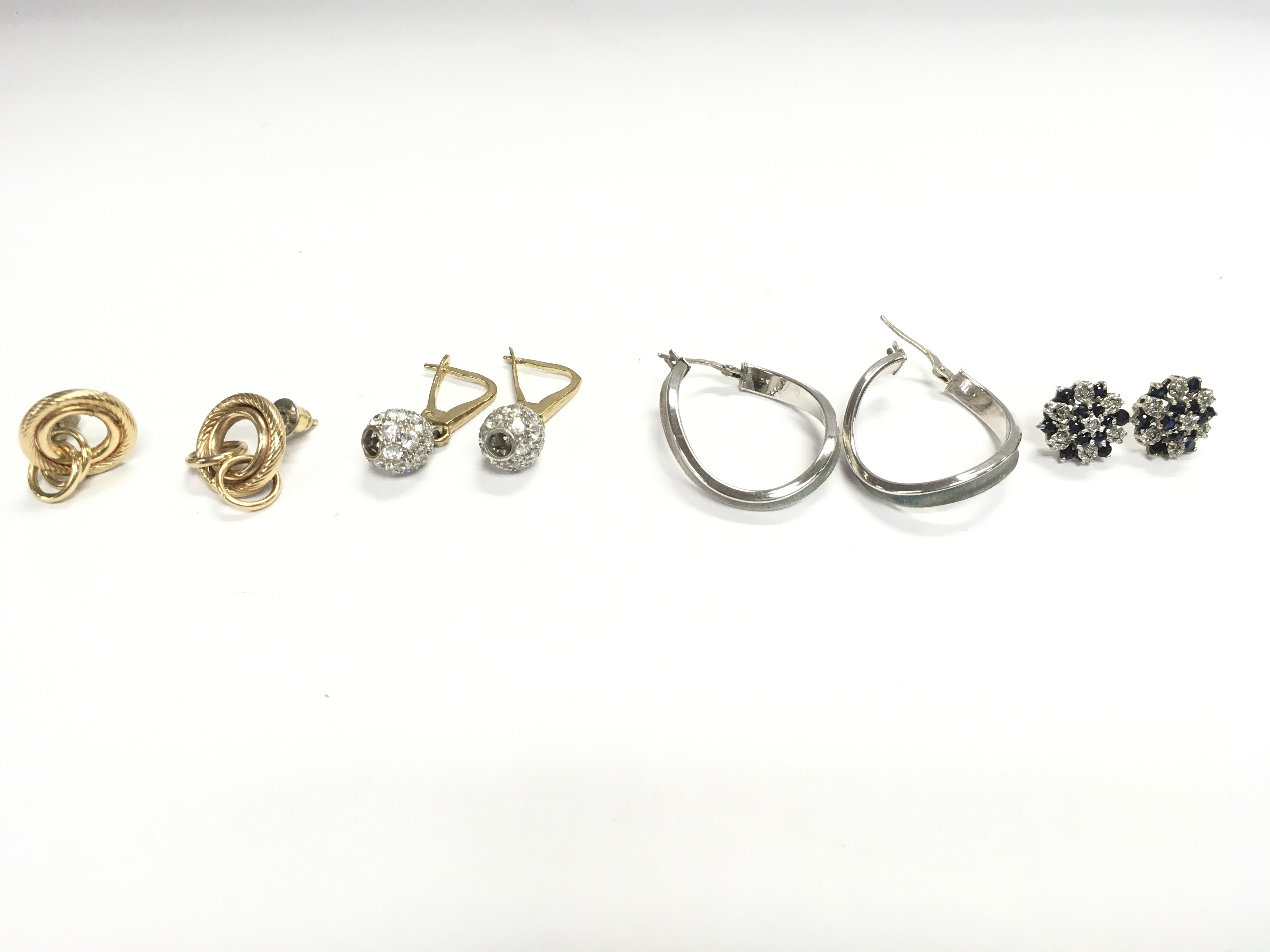Four pairs of gold and white gold earrings of various styles. 11g