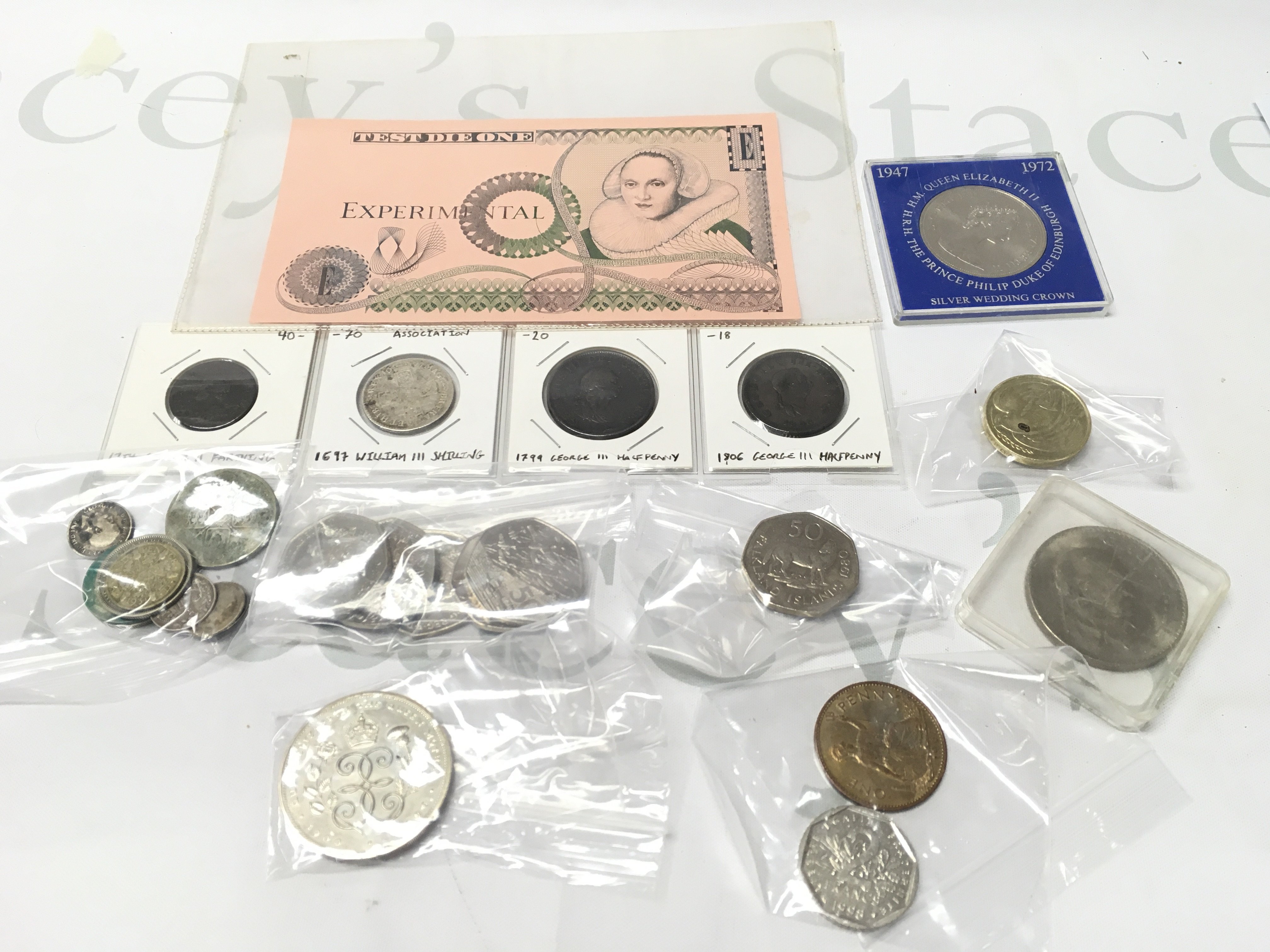 A Small Collection Of Coinage Inc A 1697 William III Shilling. 2 George III Half Pennies (1799.1806) 1754 George II Farthing Etc.