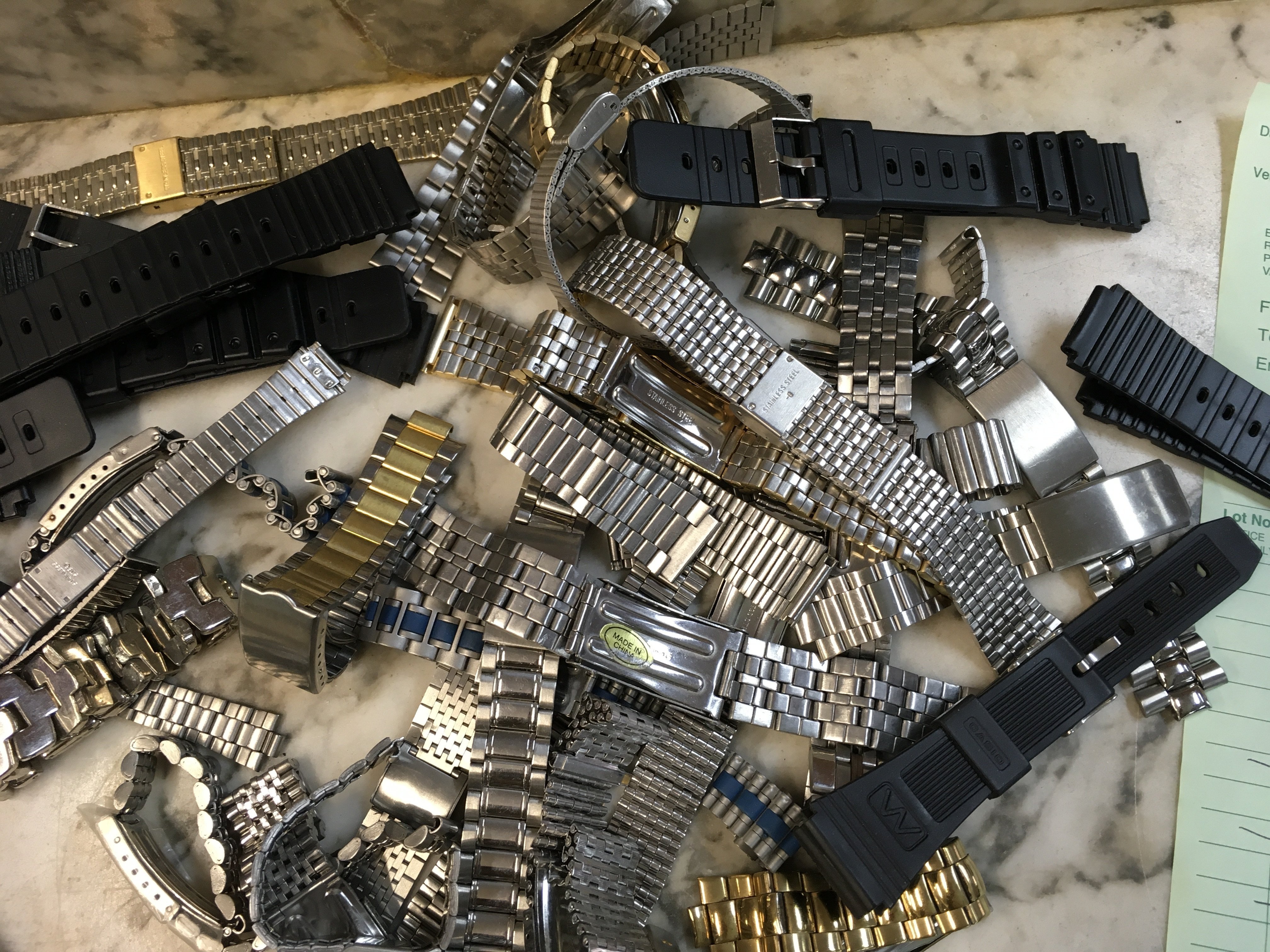 A Collection of various watch straps.together with time pieces.