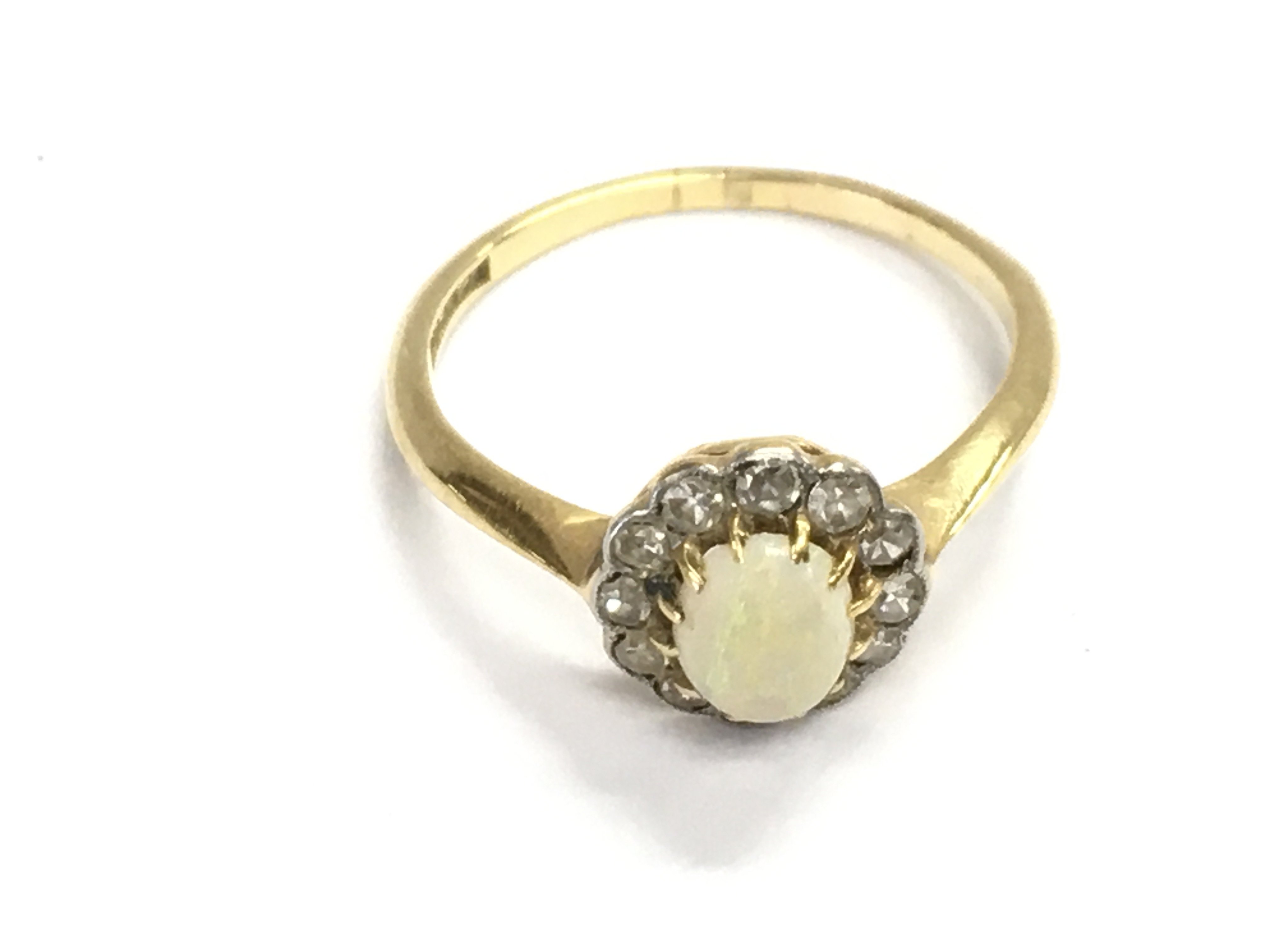 An 18ct gold diamond and opal ring. Size M and 2.13g. Postage A