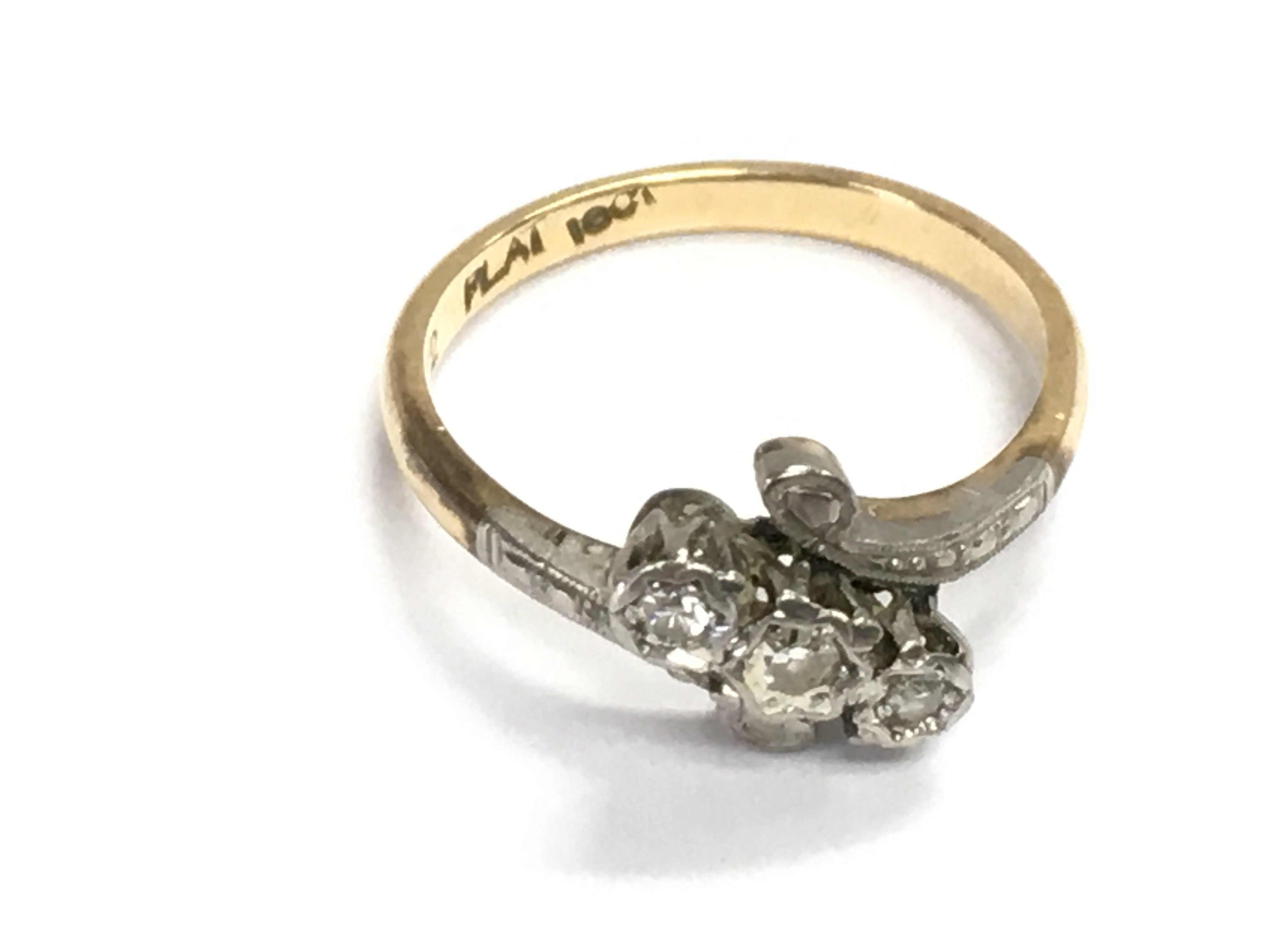 An 18ct gold ring set with three small diamonds. 2.45g and size K