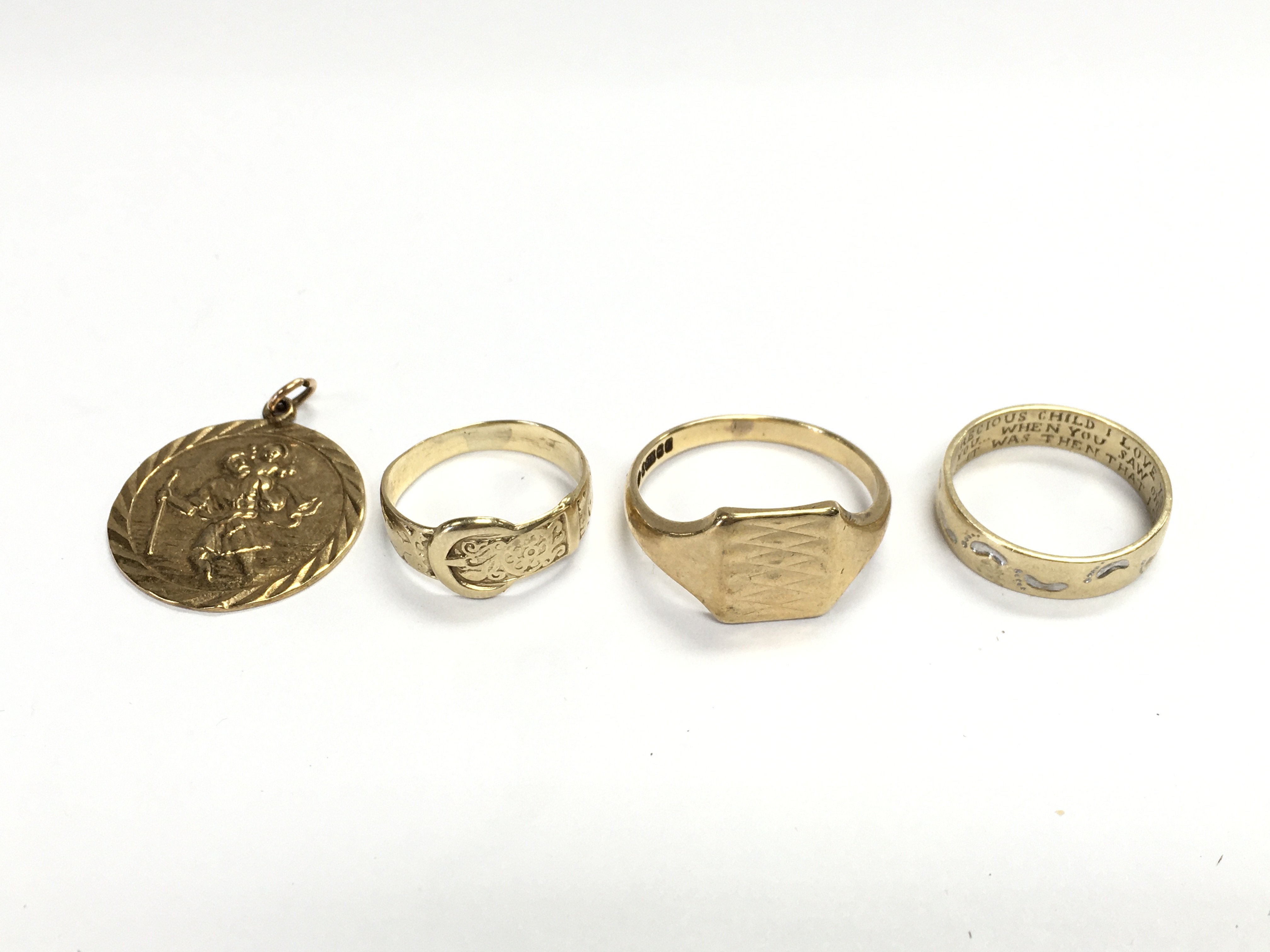 Three 9ct gold rings and a 9ct pendant. Total weight 14.18g Postage B