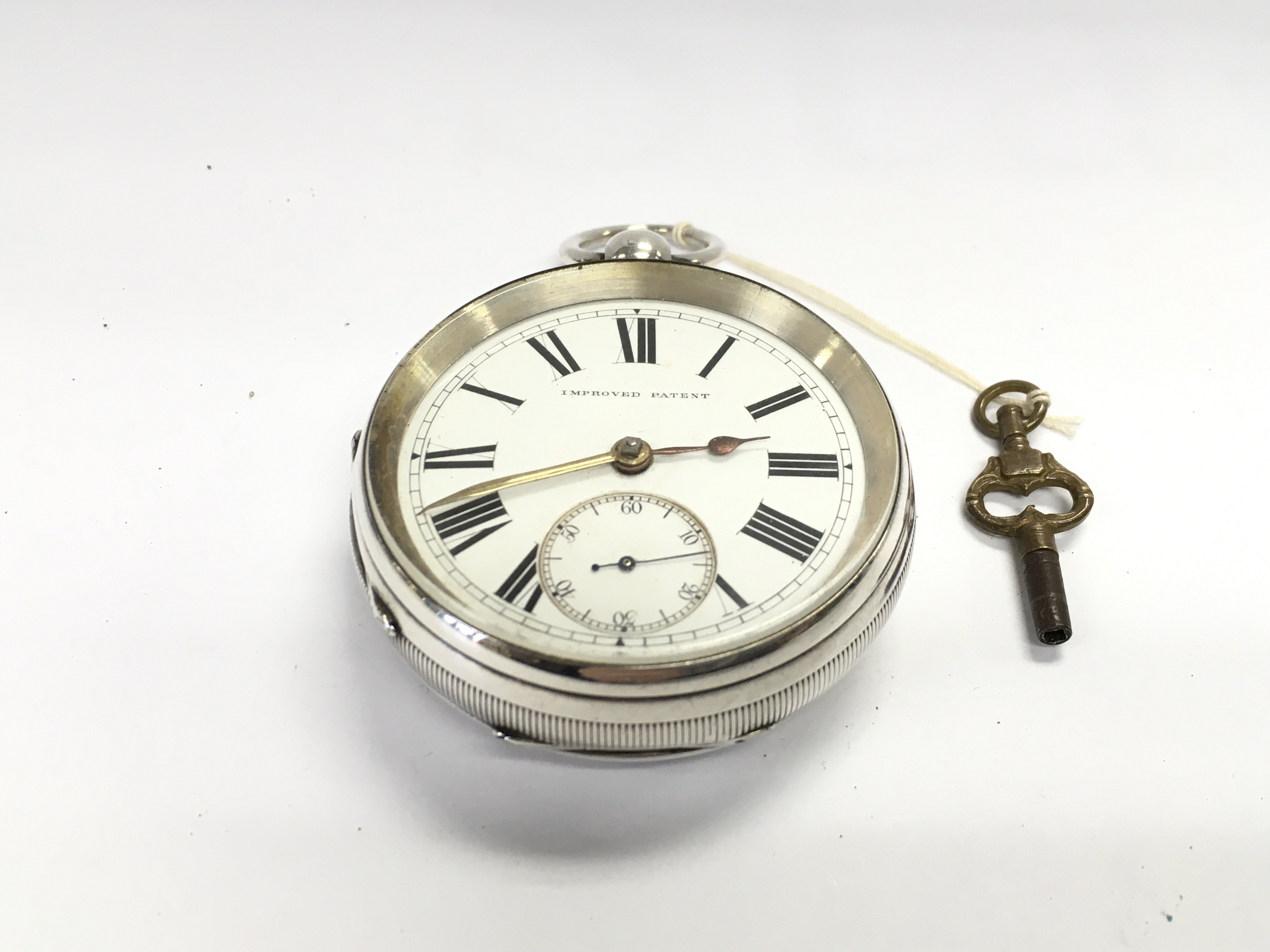 An oversized silver cased pocket watch. Approximately 55mm and 165g