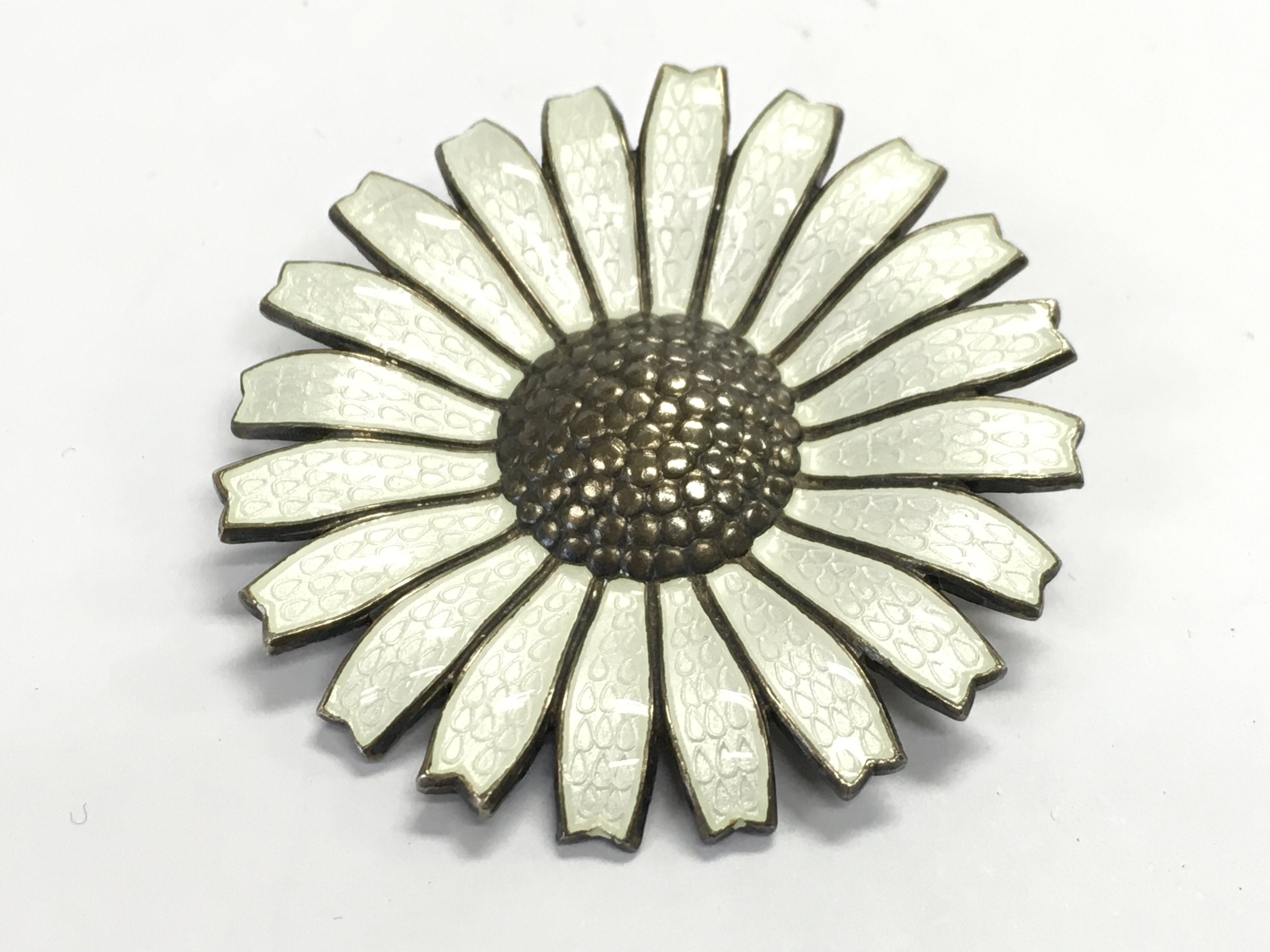 A Danish sterling silver and enamelled flower brooch by Anton Michelsen.