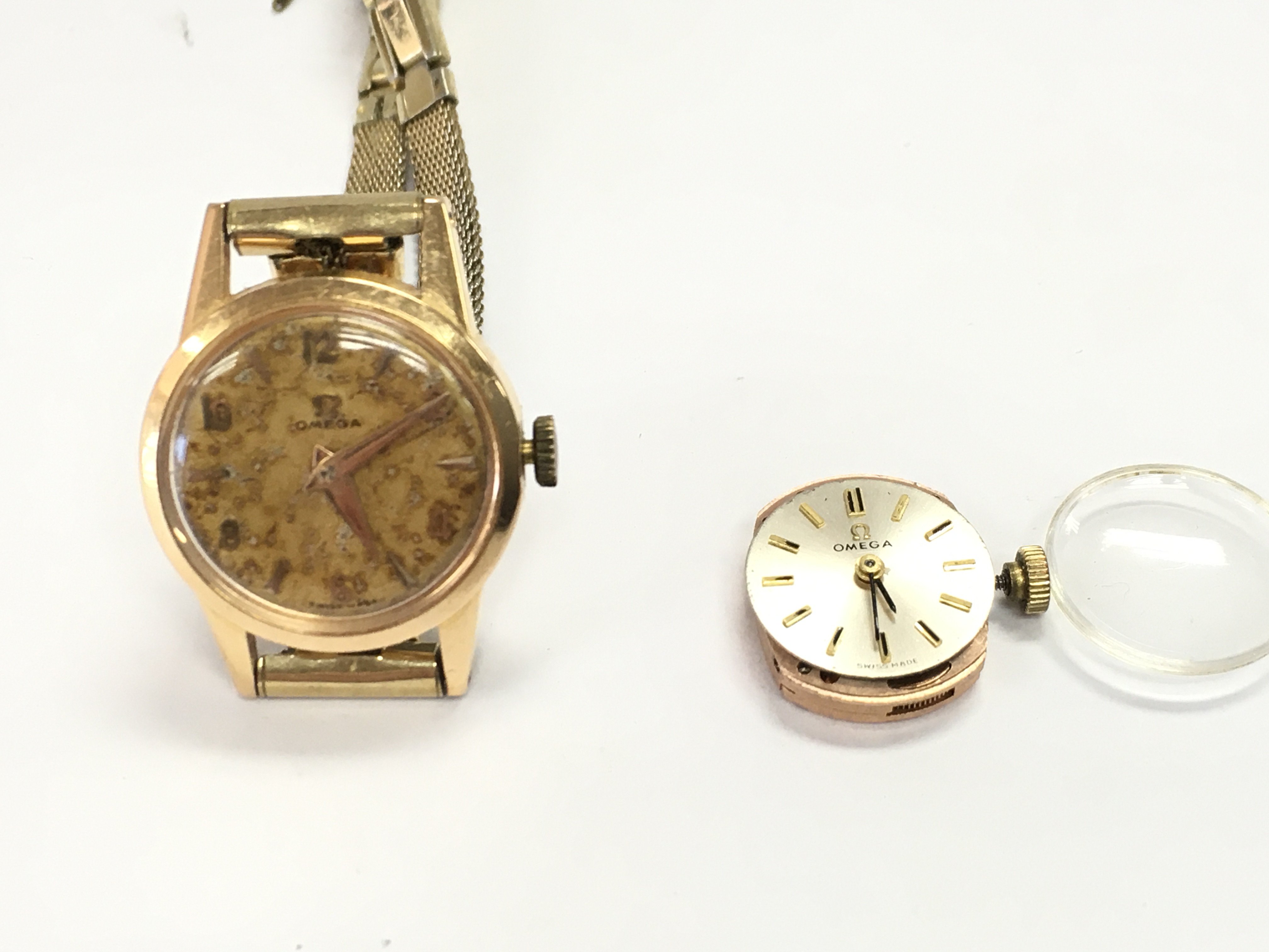 An 18ct gold cased vintage ladies omega watch with an additional omega movement. Postage B