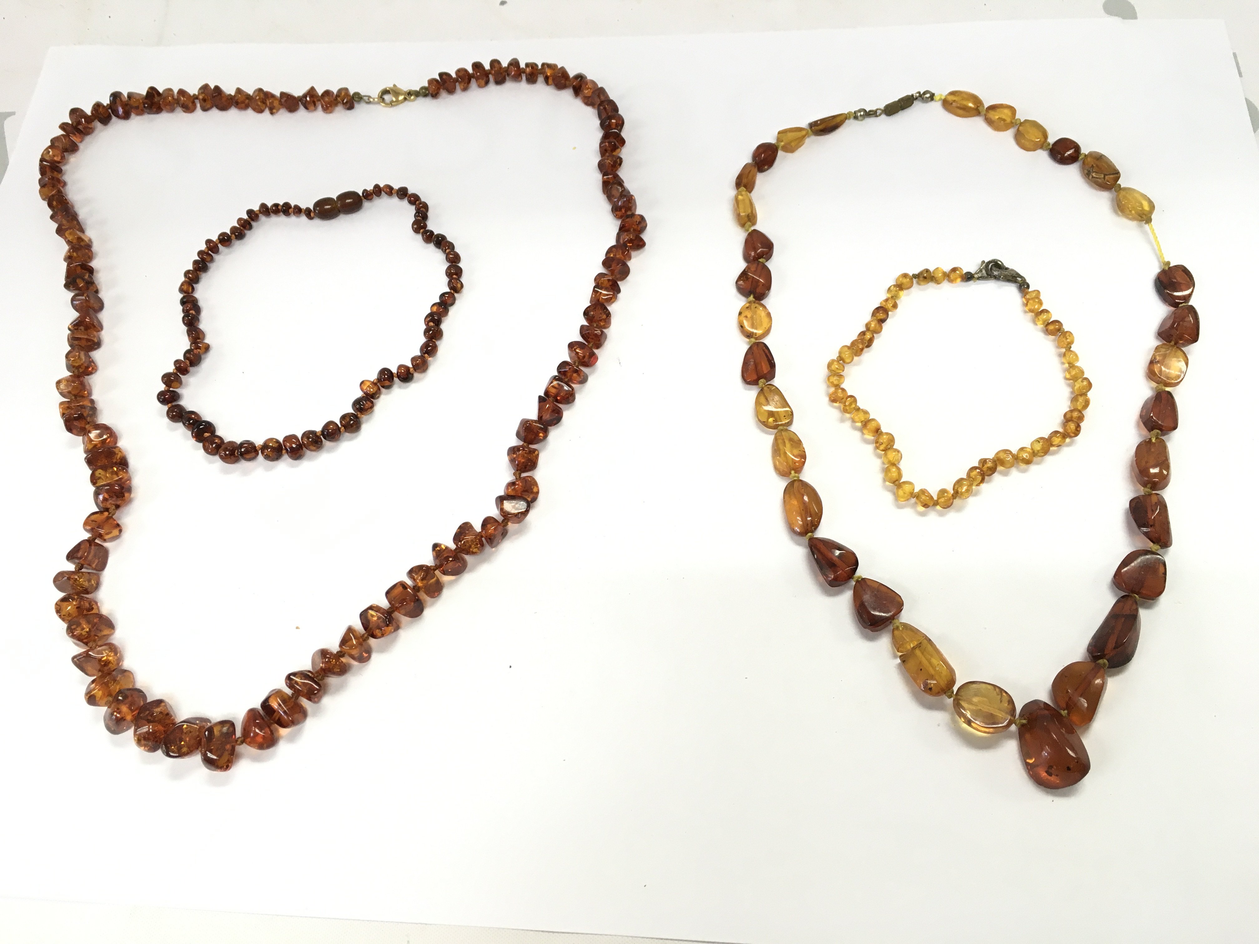 A collection of amber jewellery including necklaces and bracelet. Postage B