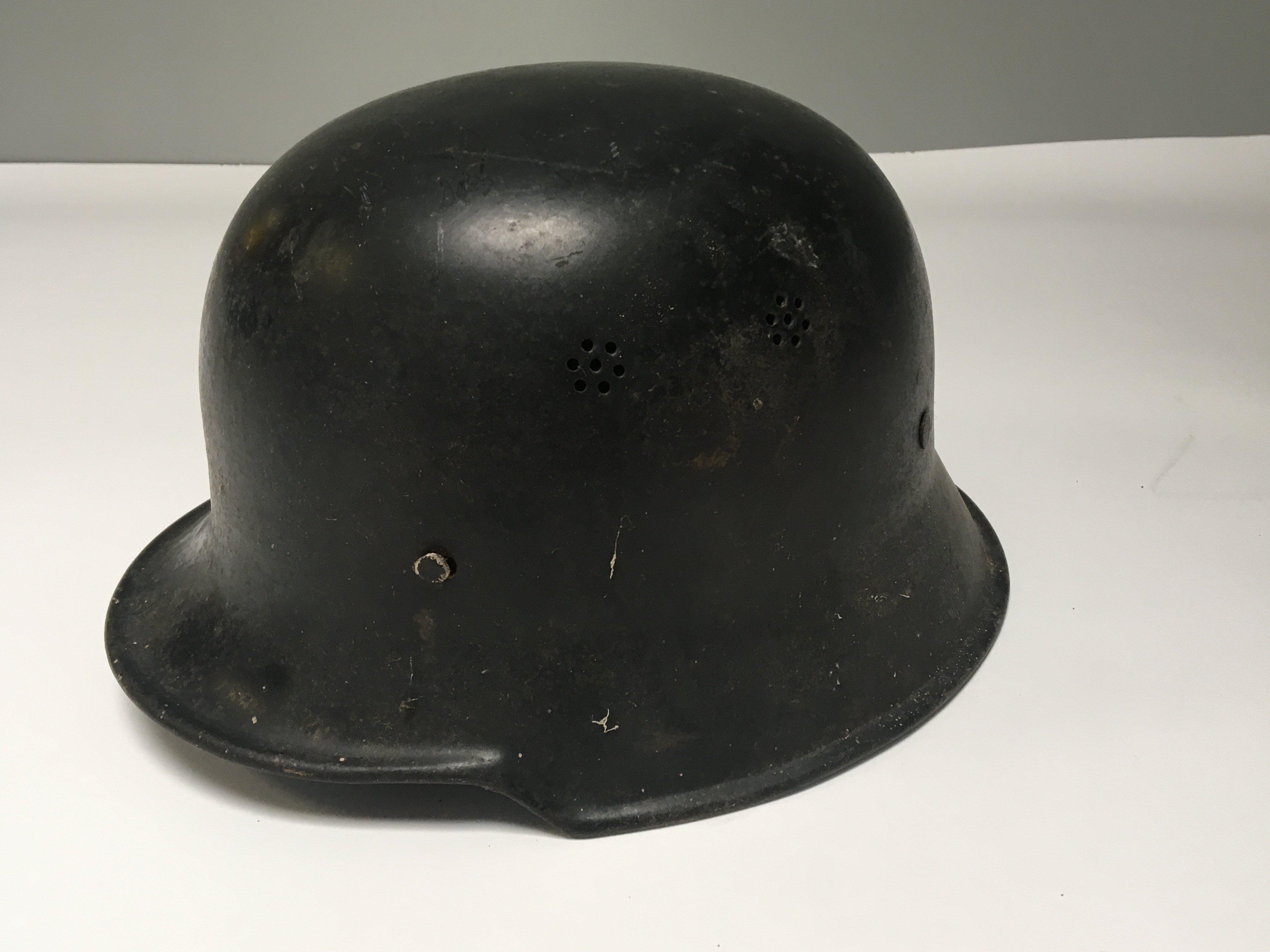 A Genuine German II world war Third Reich Police helmet black finish folded edge and with original liner.