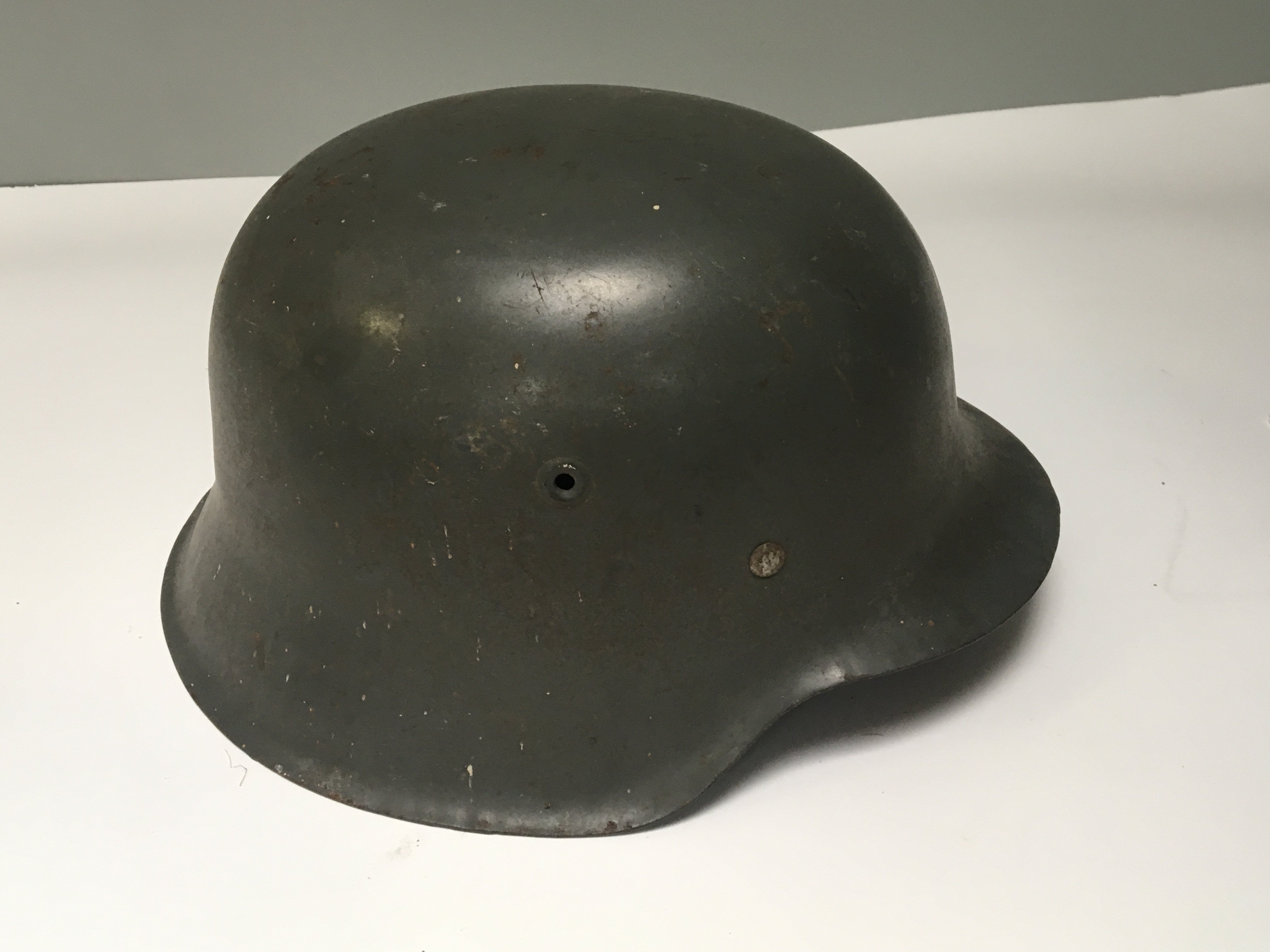 A Genuine German II world war Third Reich Military combat hemlmet M42 with original leather lining stamped number KL68 4100.