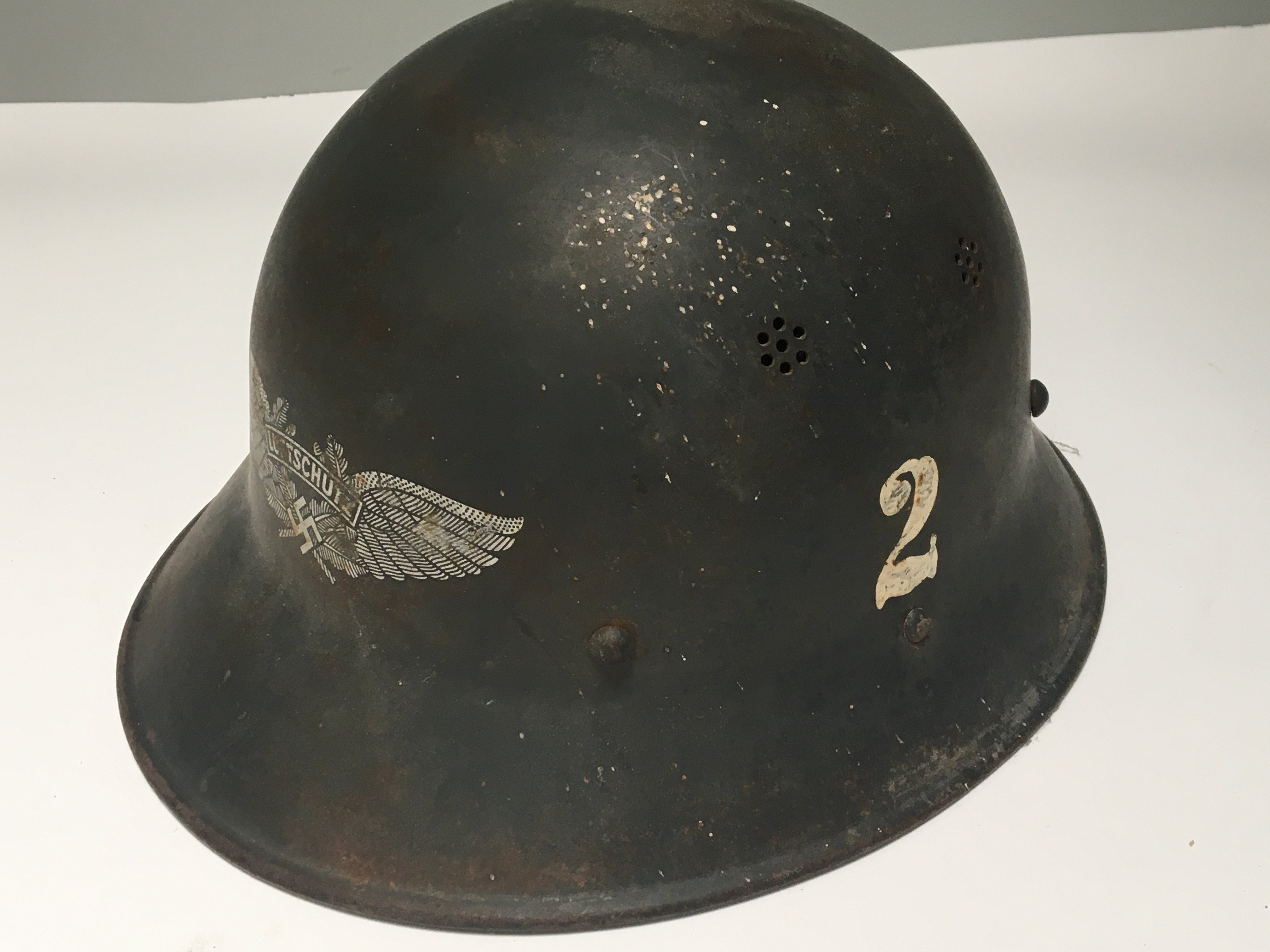 A Czech Luftschutz helmet good original condition with applied number 2 winged Third Reich front badge original lined and with applied labels.