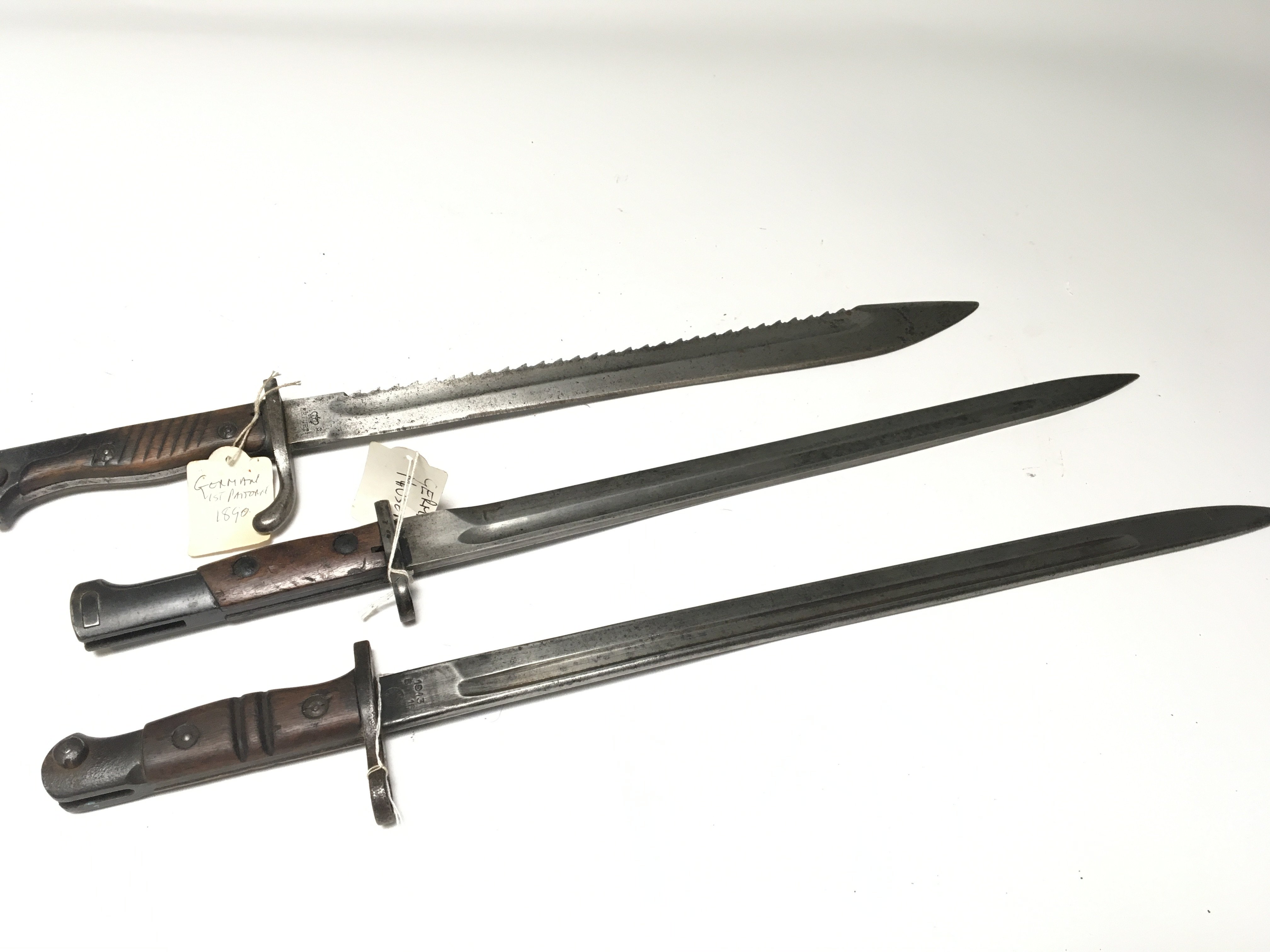 A German Imperial 1890 first pattern pioneers bayonet with saw edge a Remington 1913. and one other German Mauser bayonet no scabbards (3)
