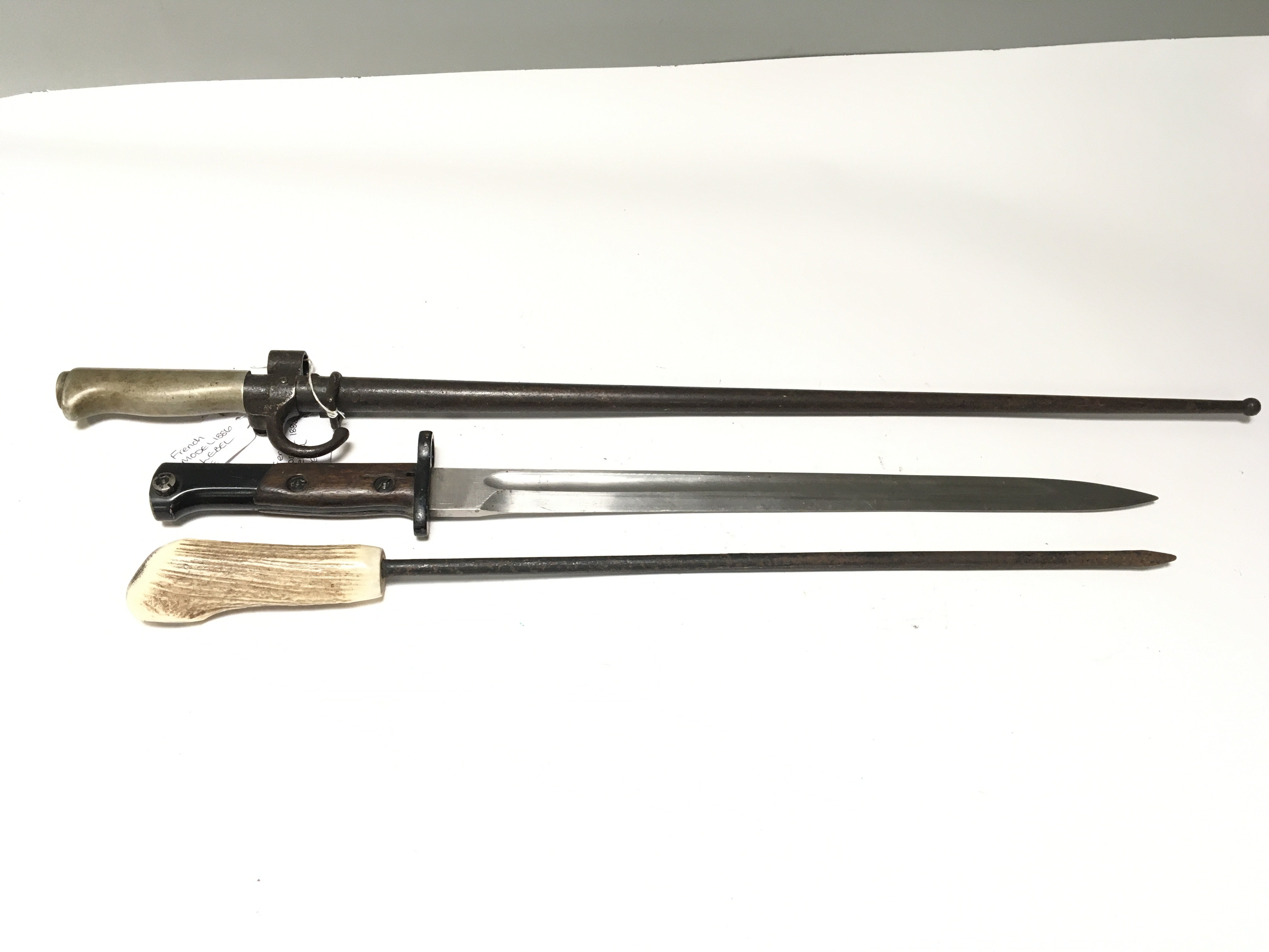 A French stick bayonet 1886 Label pattern with a steel scabbard one other unmarked Mauser bayonet and a horn handled long spike (3)
