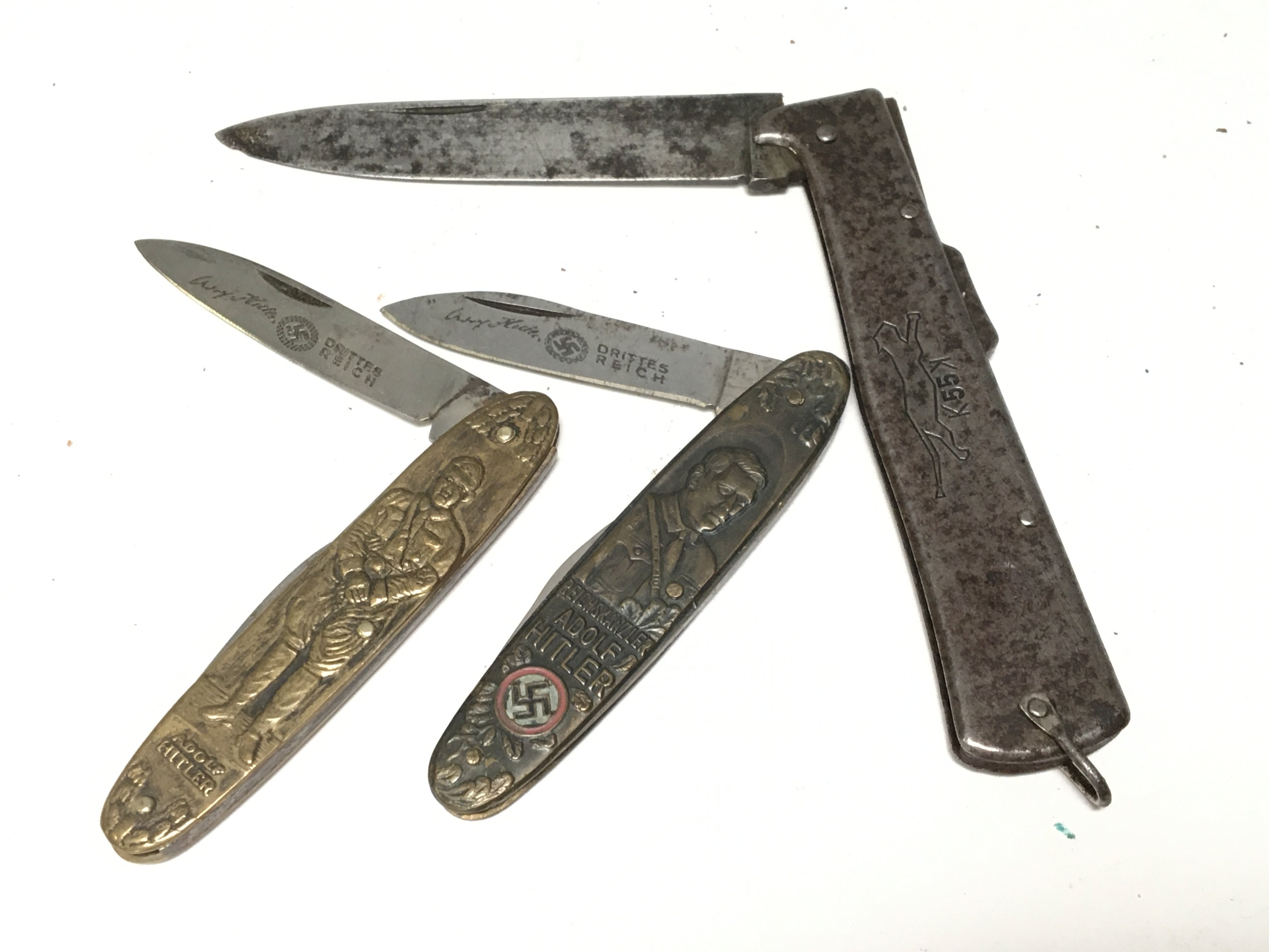 Two German Third Reich Adolf Hitler brass cased folding pocket knifes with German swastika etched blades and one other German knife the K55K maker Mercato Solingen (3)