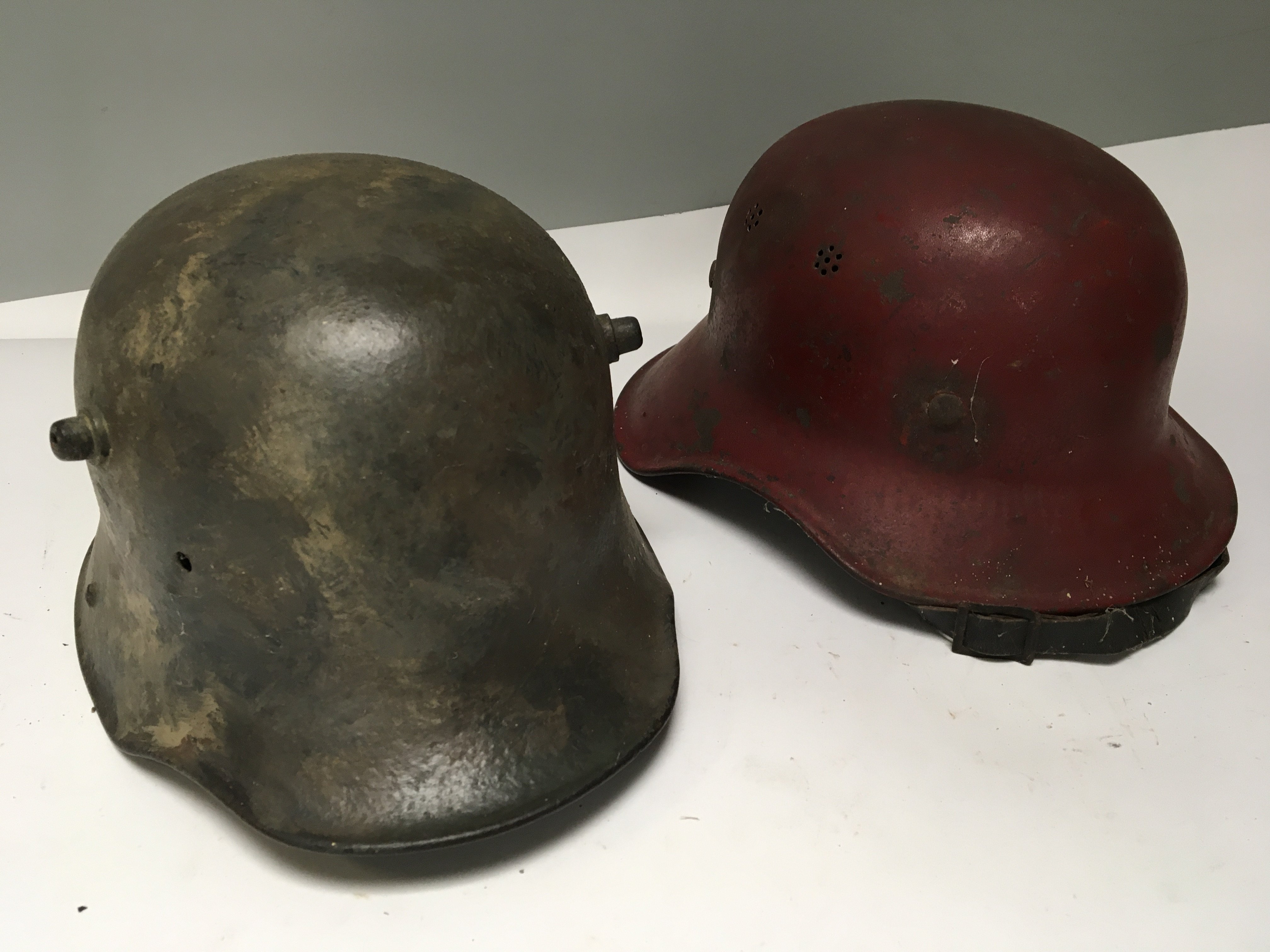 A Genuine I world war German Imperial Army steel combat helmet M-16 with painted internal name and number and a Post Second World War German red firefighter helmet (2)