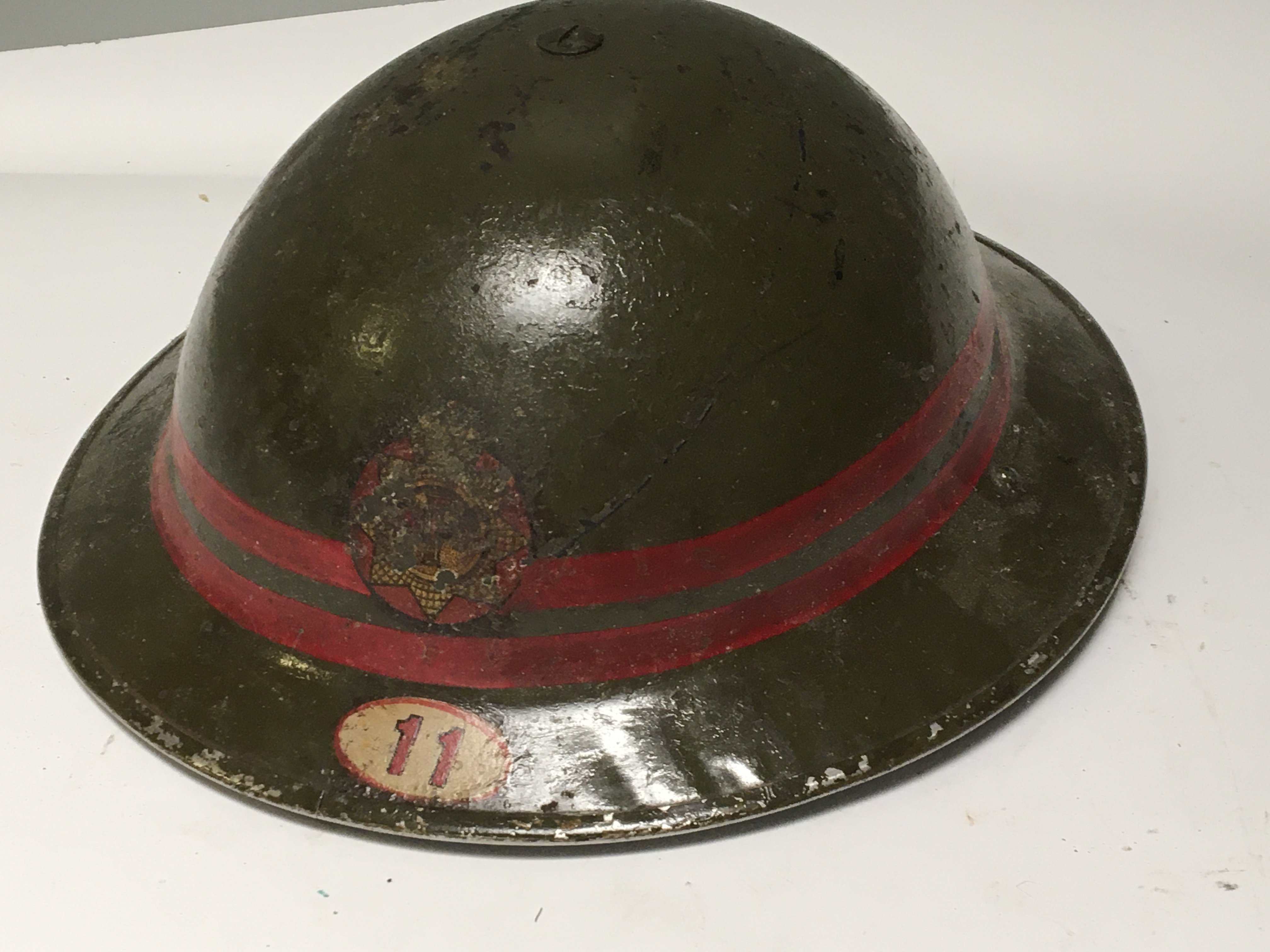 A II world war National Fire Service issue helmet with badge and 11 decal and a set of buttons .