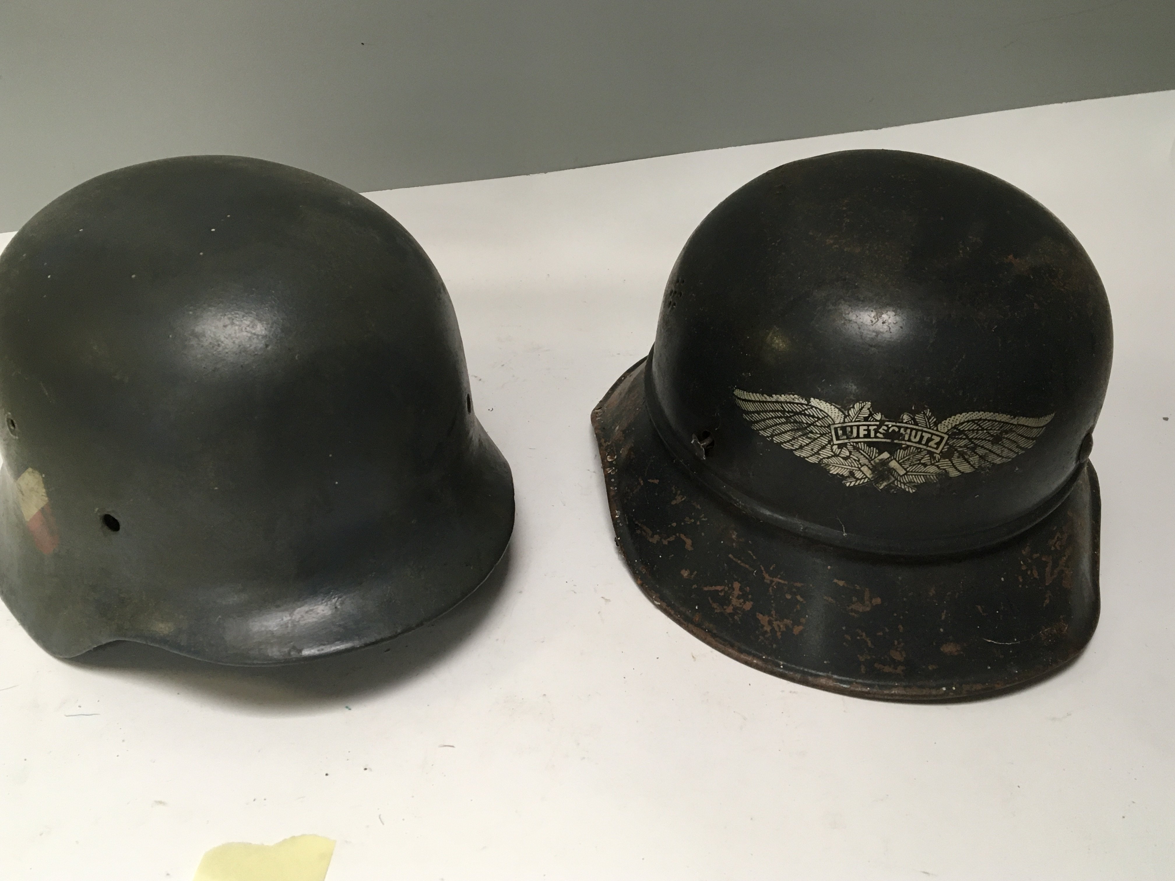 A German Third Reich Luftwaffe double decal steel combat helmet possible an earlier M35 pattern no liner and a Luftschutz Czech helmet with Mauser decal (2)