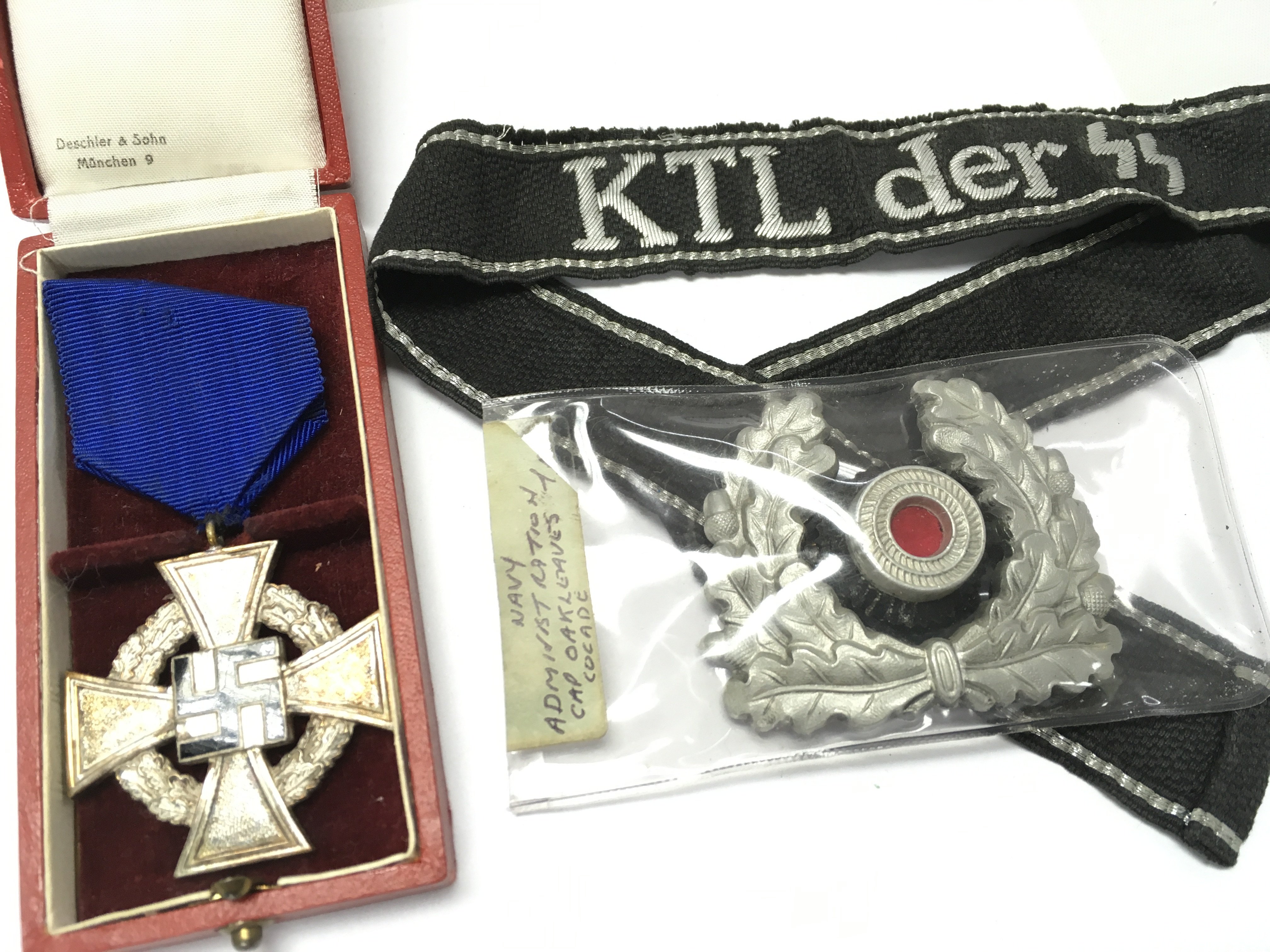 German Third Reich Collection including a boxed faithful service medal, SS cuff title, Navy administrator cap badge. Postage category A