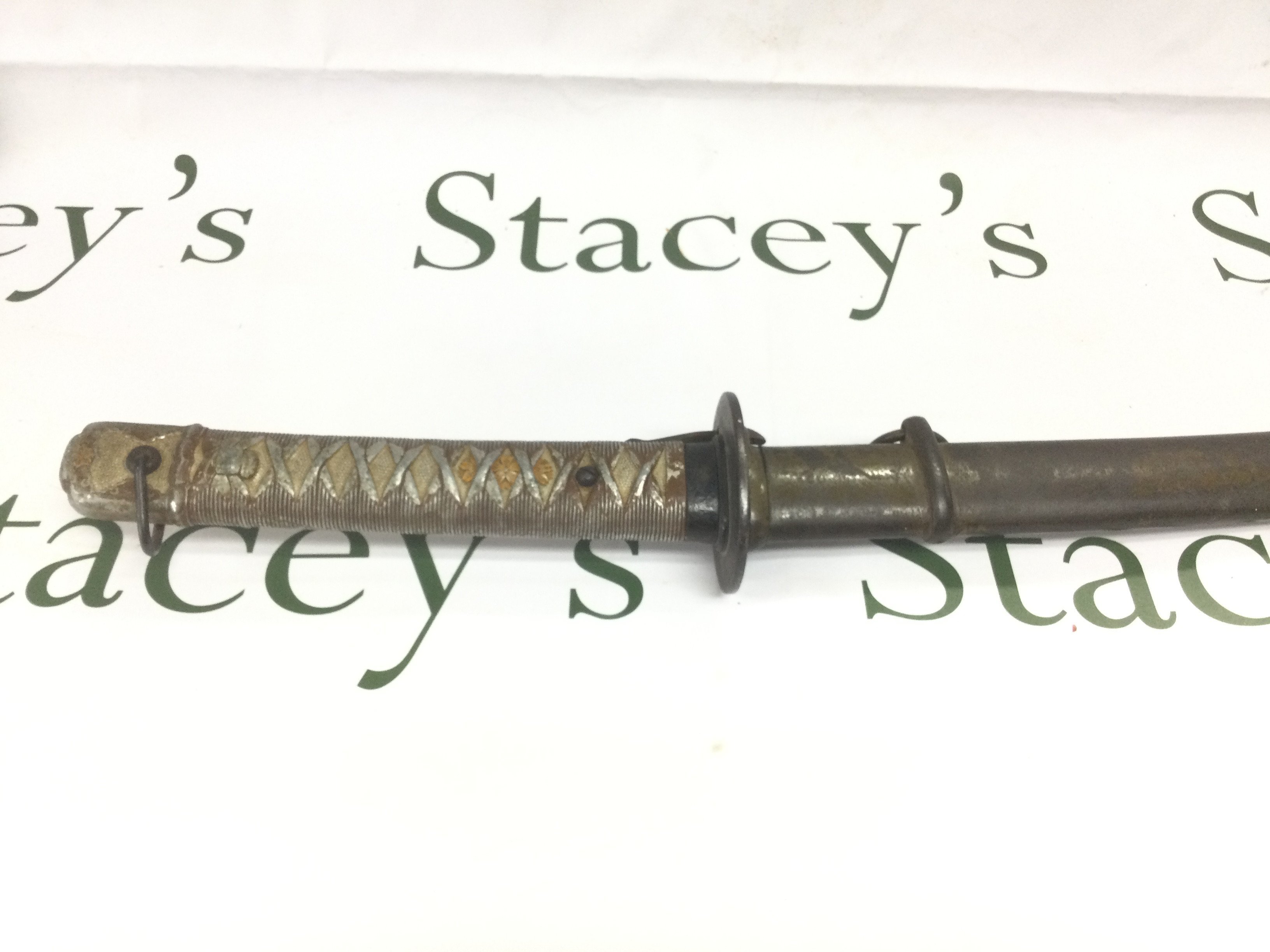 A mid 20th Century Japanese sword and scabbard. Blade length 66cm. Shipping category D.