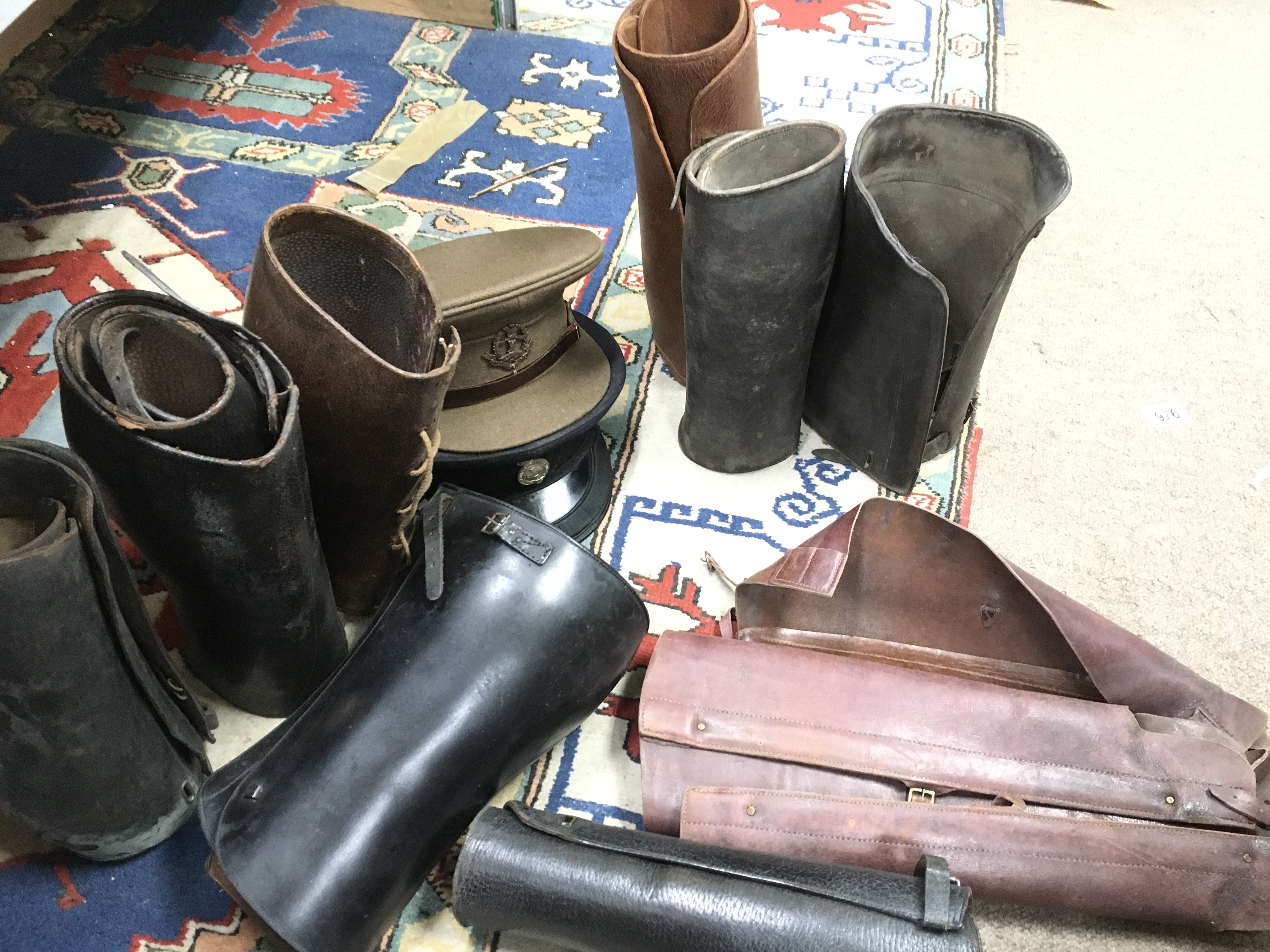 A collection of military hats including a Malay States Volunteer Rifles officers cap and a Middlesex Reg officers cap and leather leggings. This lot cannot be posted