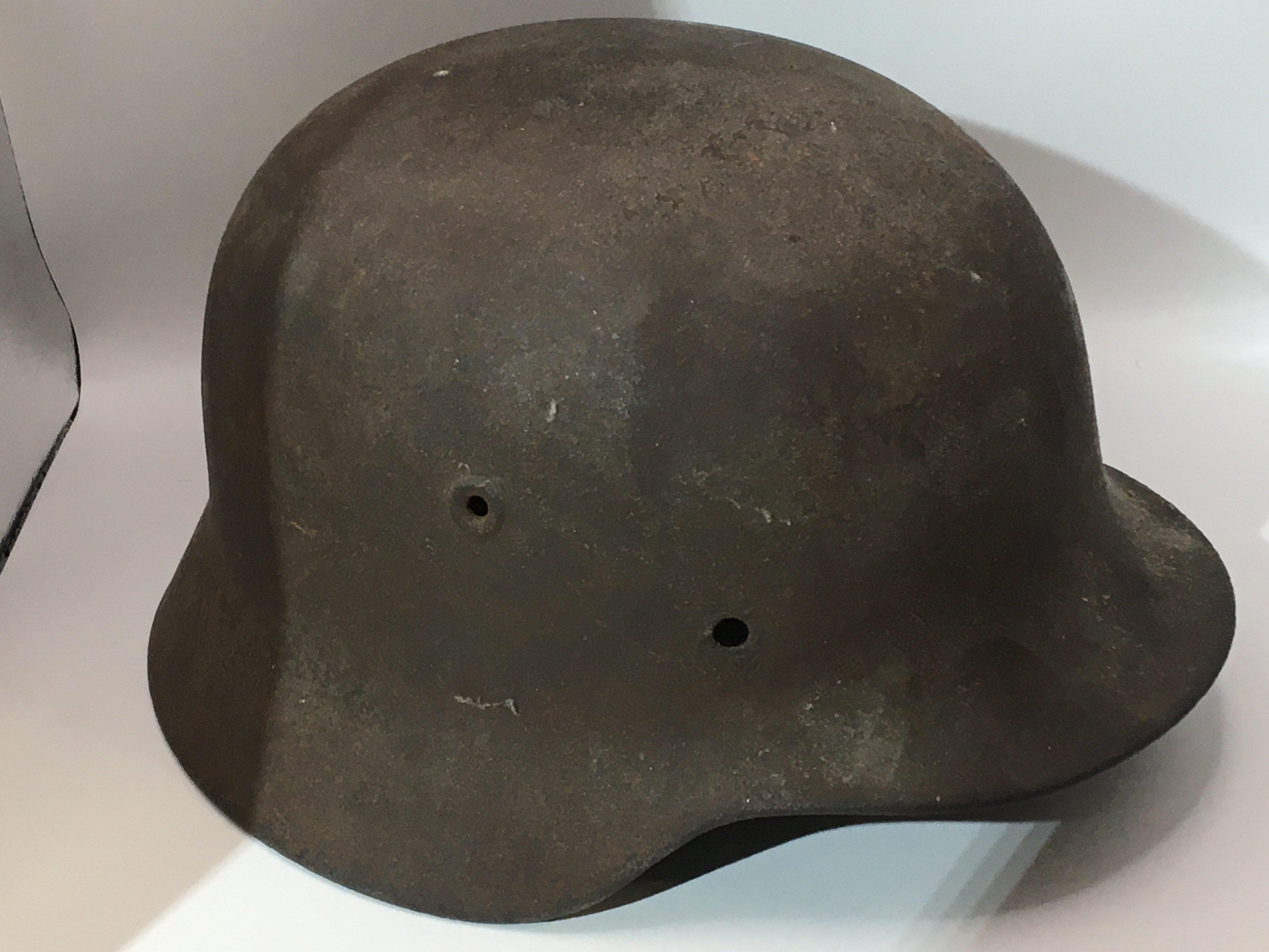 A German Third Reich Steel helmet with faded side decal possible M35 pattern no inner lining. Circa 1942