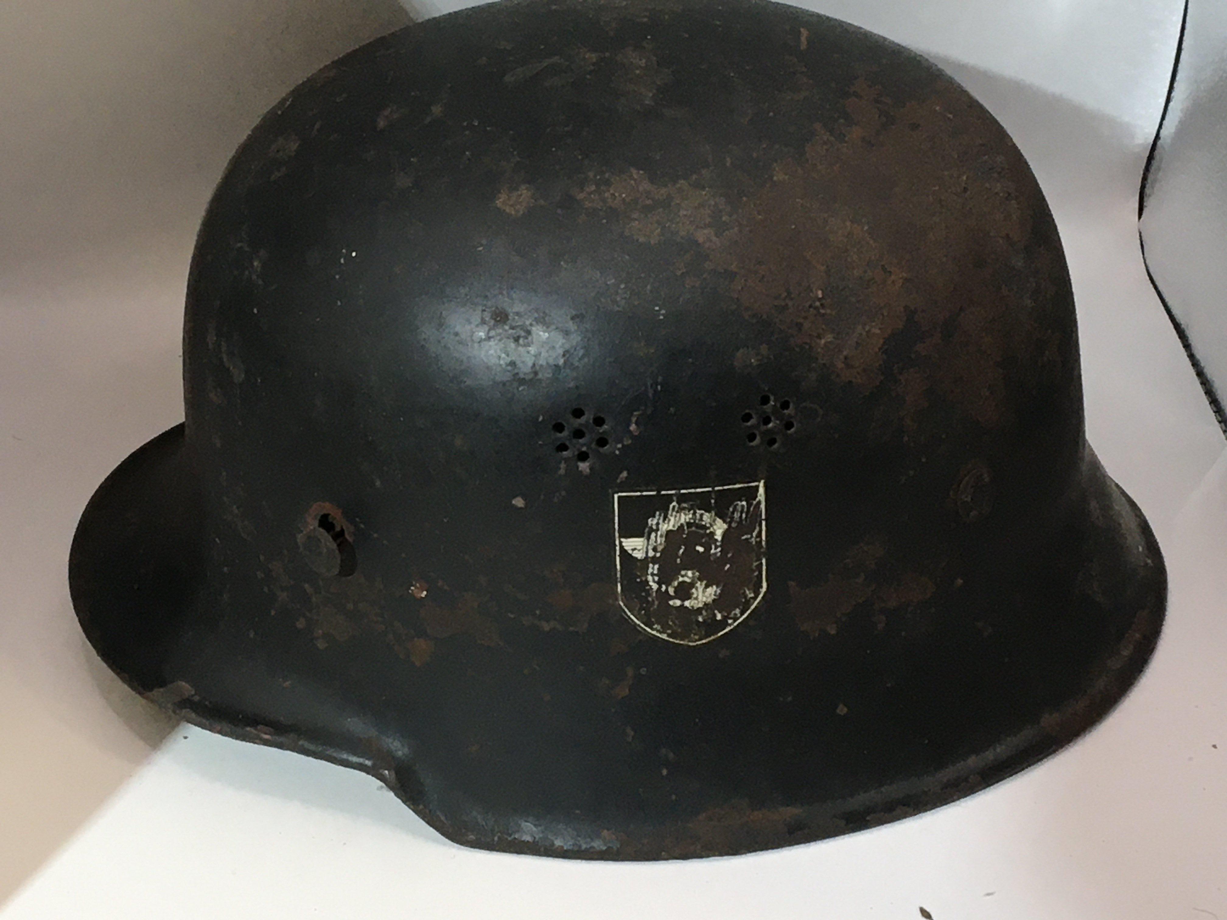 A German Third Reich II world war military helmet original condition with double side decals has a worn but original liner. The helmet with air breather holes and inner edge stamp mark