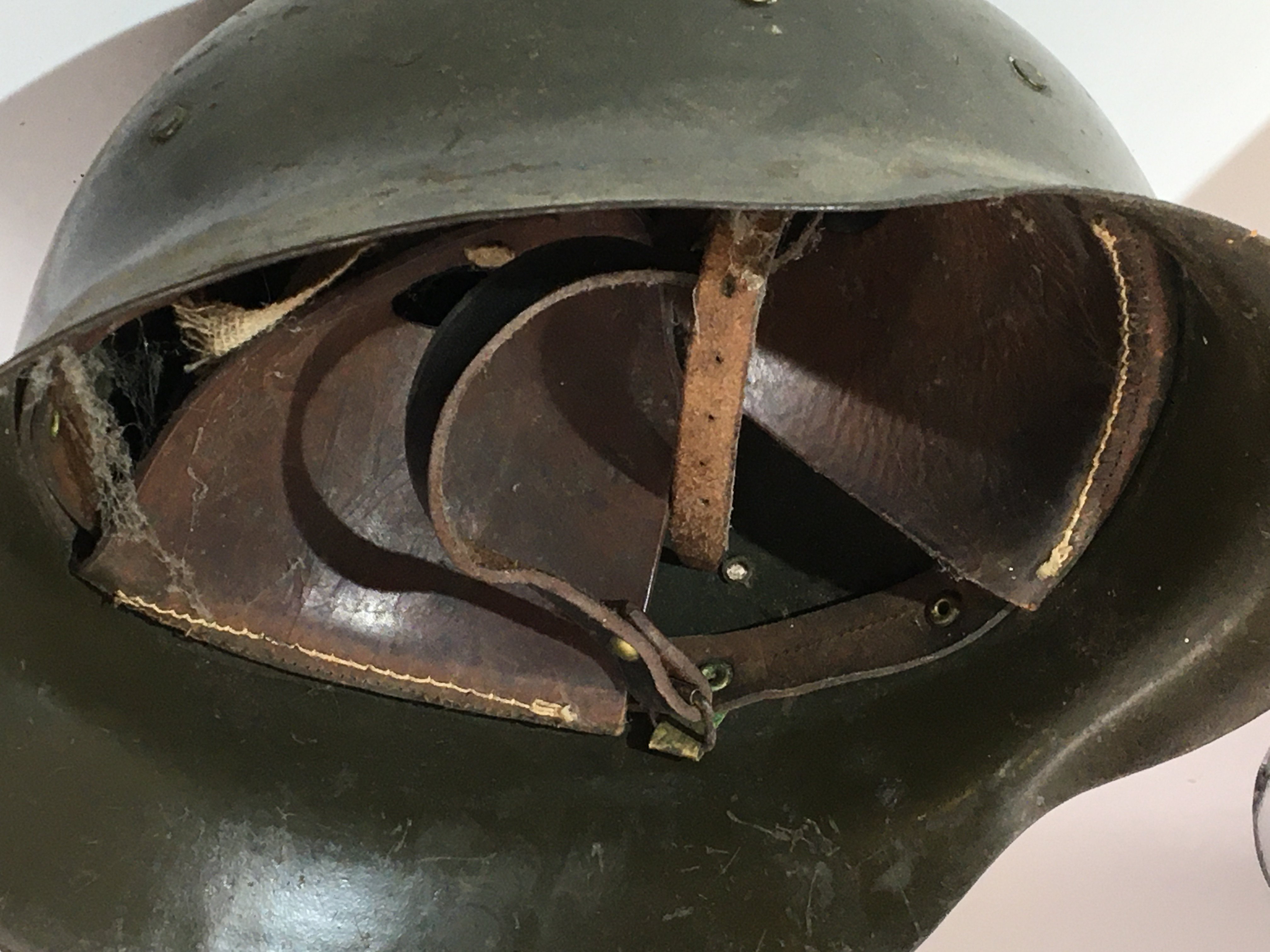 A German Third Reich M42 pattern helmet green with attached bracket above the peak thick cut leather liner. No obvious stamp marks.