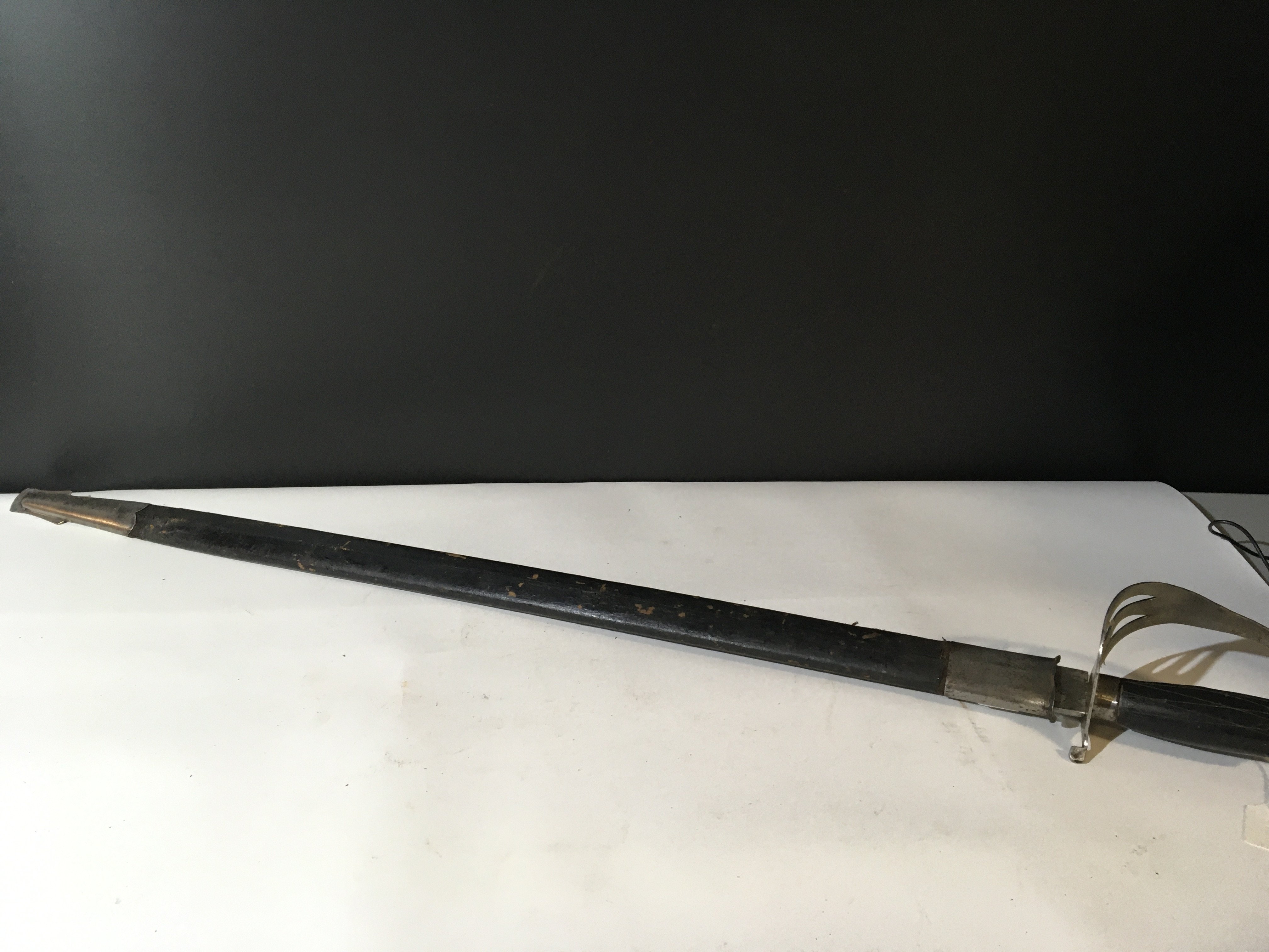 An Indian military sword the blade with an inscription and makers stamp. NO RESERVE
