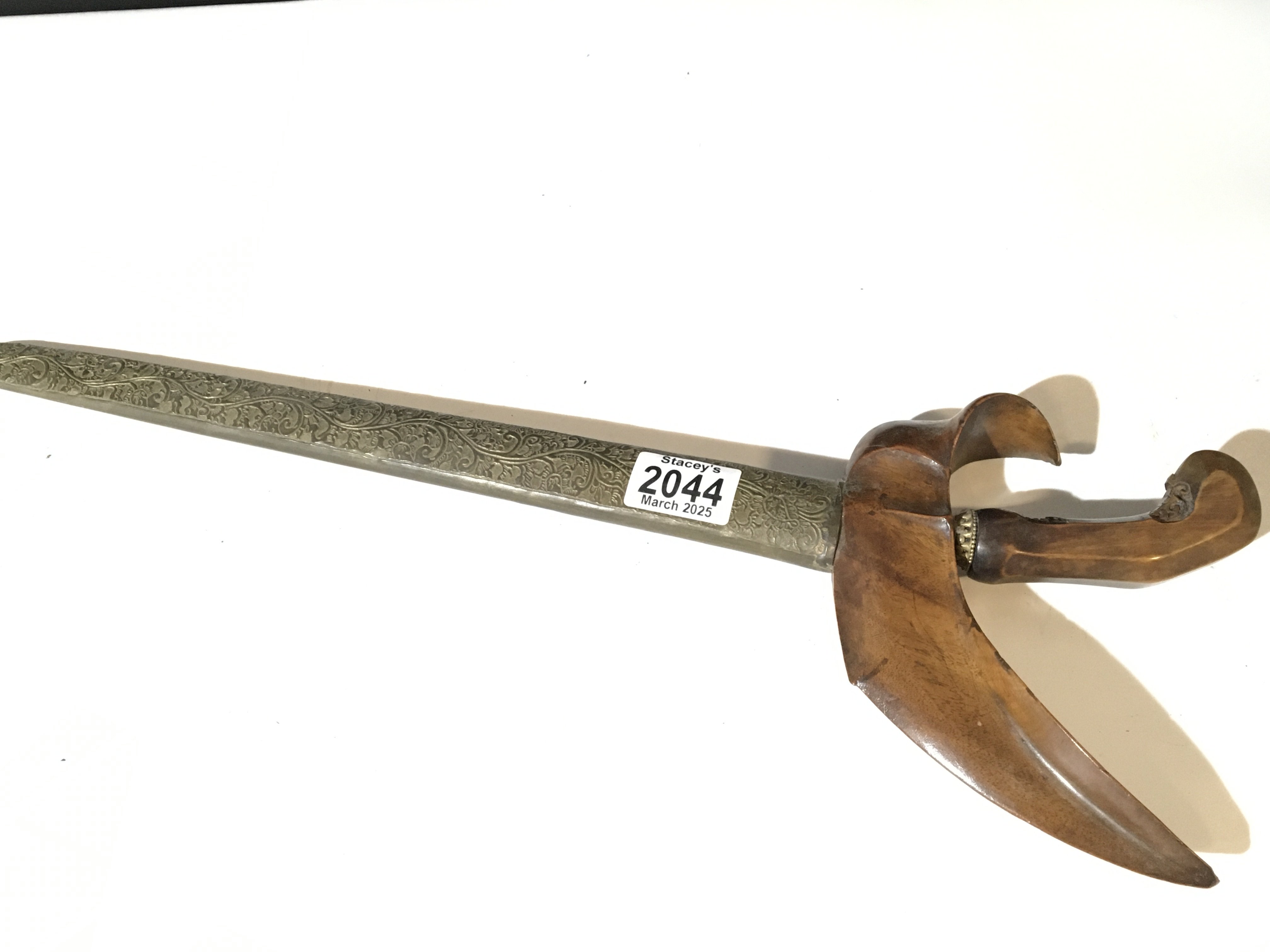 An Indonesian Kris Knife with carved wood grip and patterned scabbard. Good condition. NO RESERVE