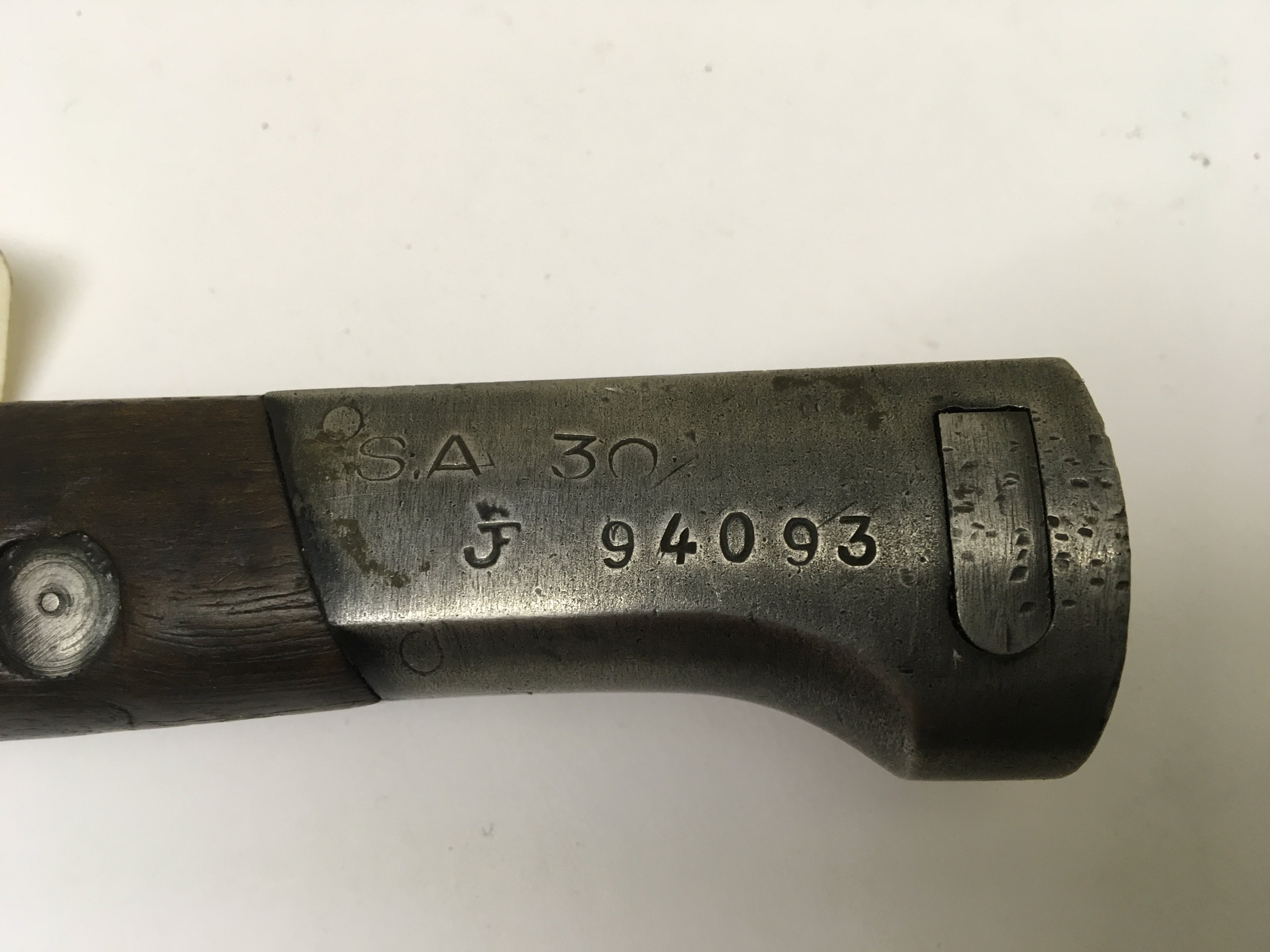 A German Imperial Colonial overseas forces bayonet S71/84 with a wood and steel grip stamped SA30 with a green canvas frog metal scabbard. Length 38cm