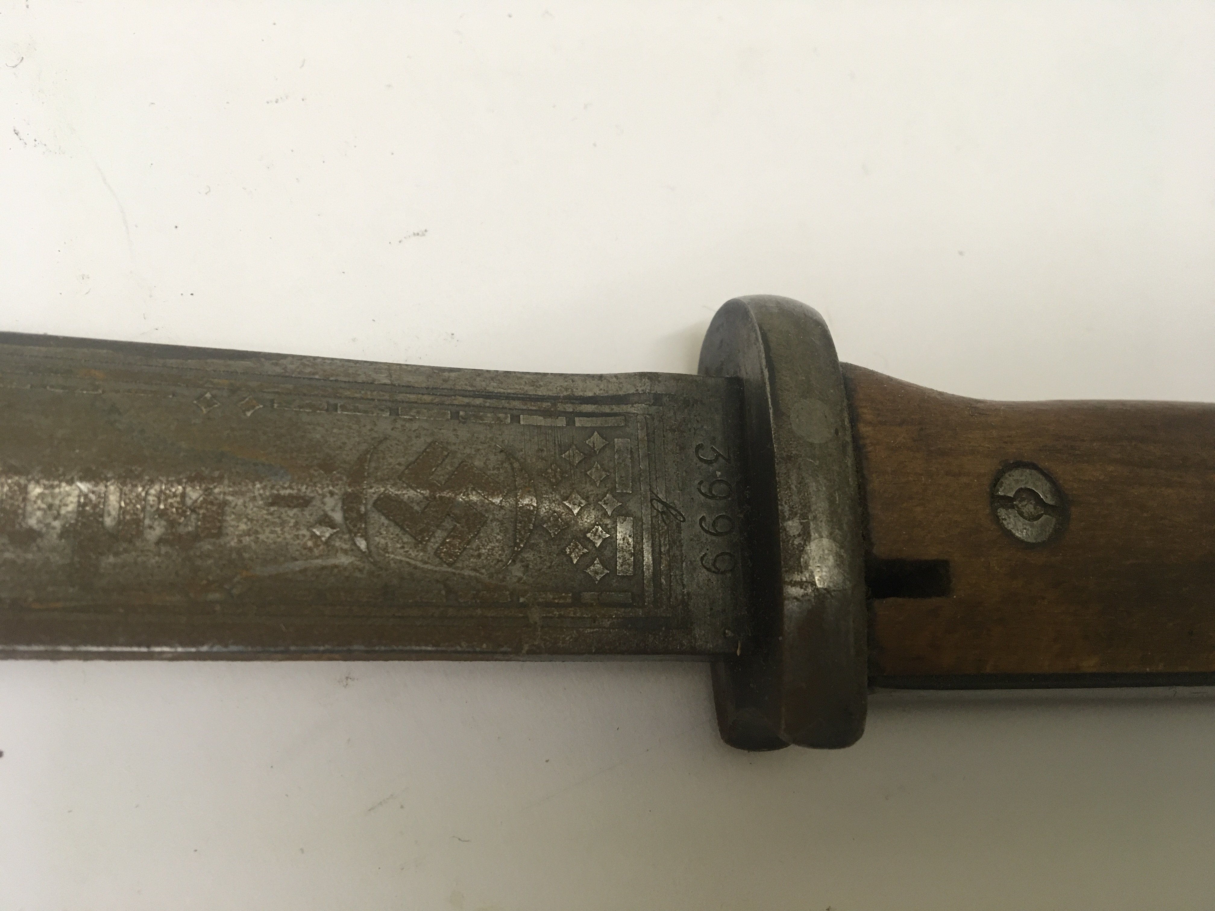 A German Third Reich Afrika Korps bayonet the etched blade Deutsches Afrika Korps the reverse with further etching and dated 1941 the top fitting with a f etched palm tree symbol. No scabbard length 38cm