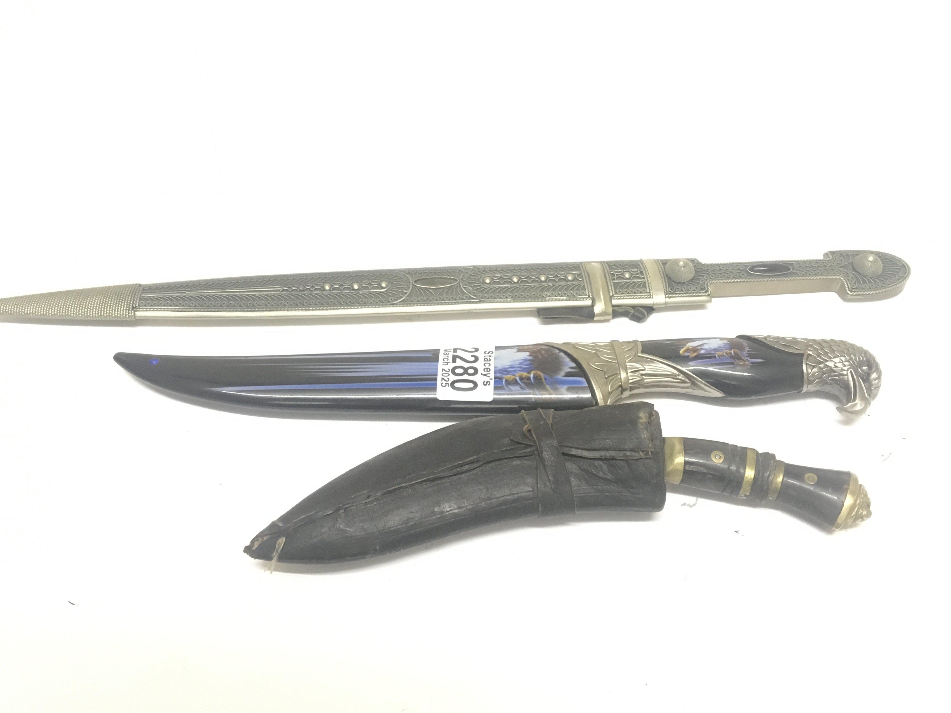 A Middle Eastern dagger with fillagree metal decoration an American Eagle knife and a small Kukri knife (3) NO RESERVE