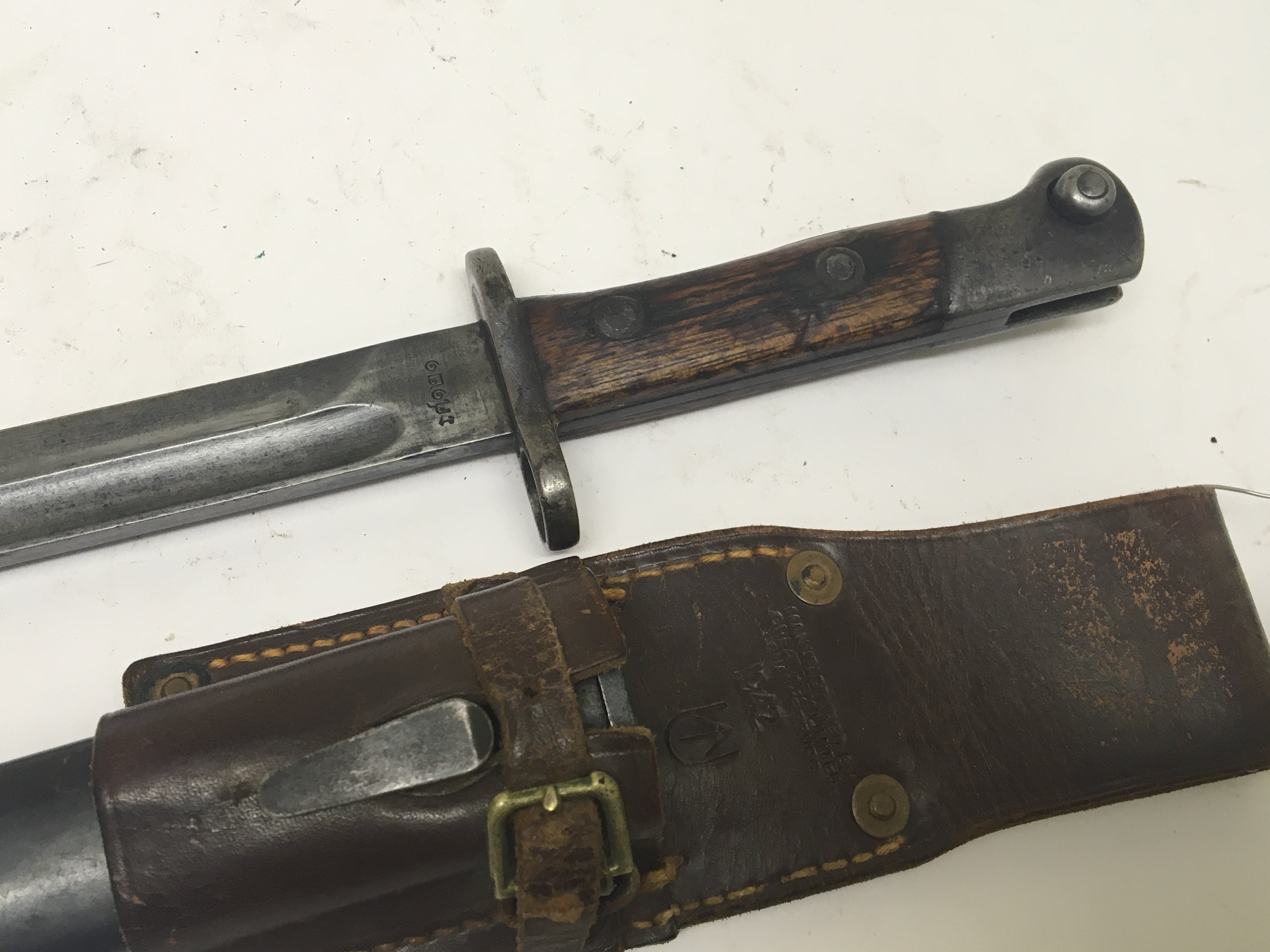 A K98 bayonet with an interesting leather frog stamped 1942 with a South African manufacture Greatrex ltd the blade of the bayonet with further marks. NO RESERVE