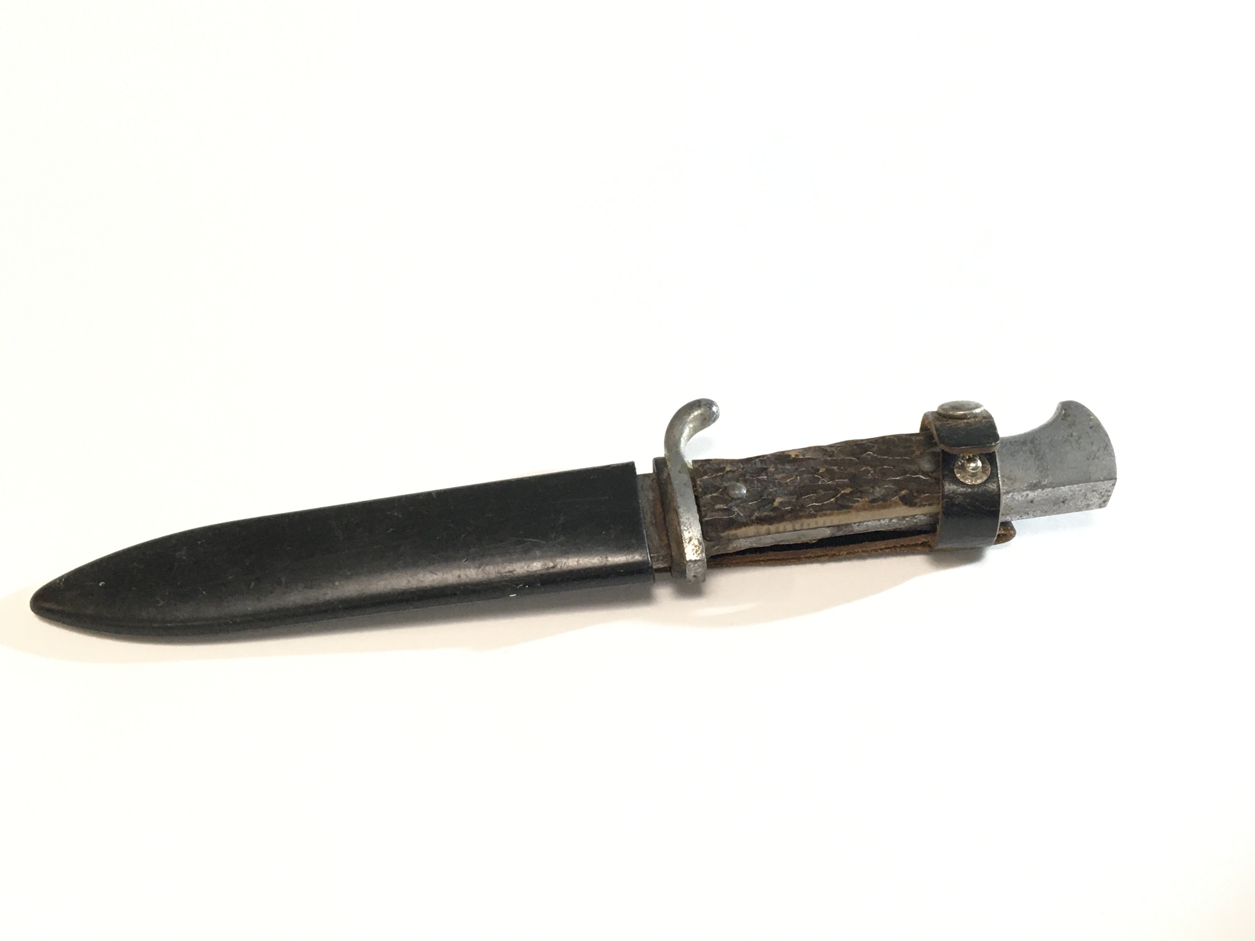 A German Third Reich knife with a horn handled grip marked Solingen possible a Hitler youth knife.