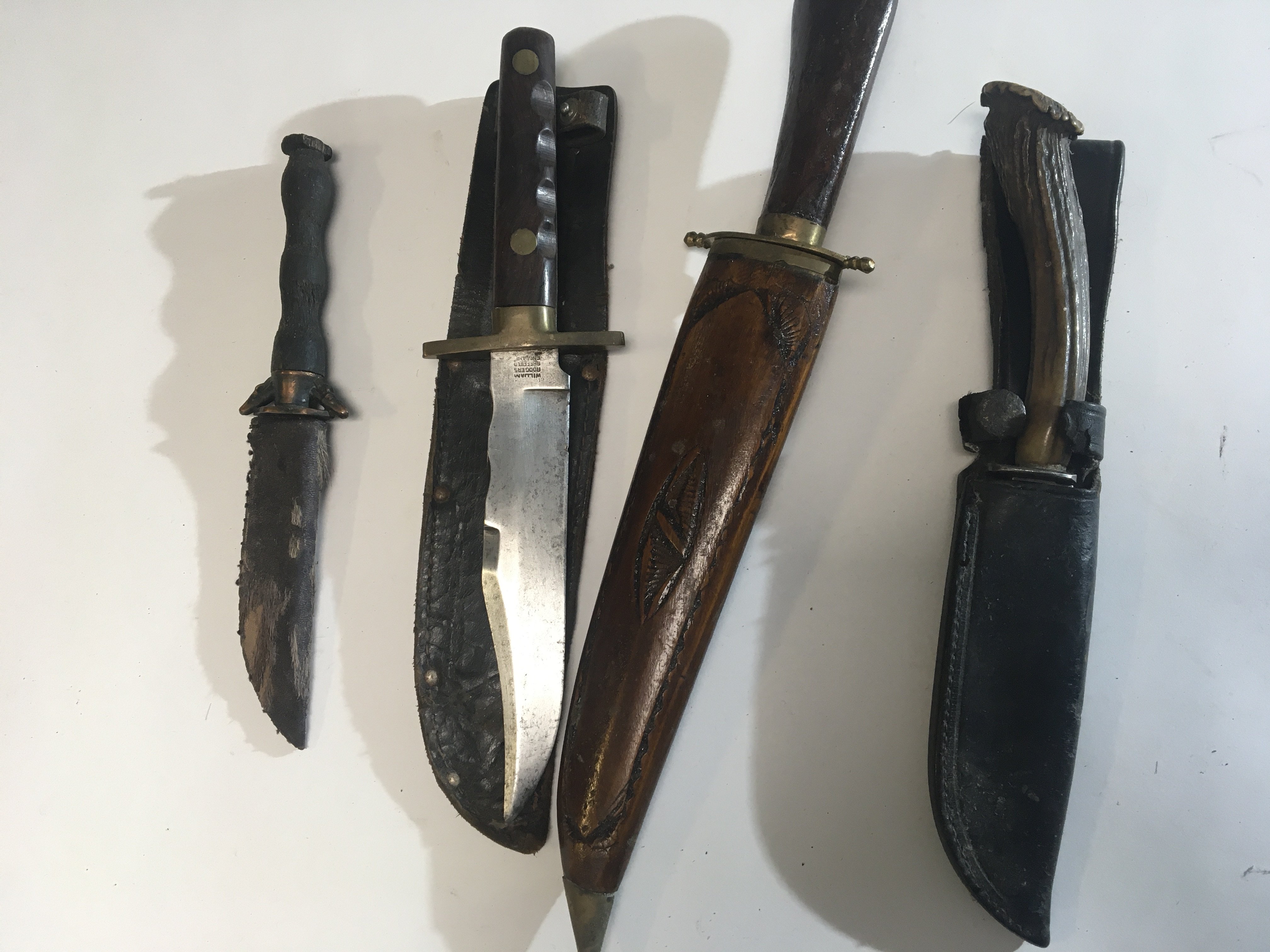 A collection of four Vintage hunting knifes one with makers stamp William and Rodgers Sheffield and three others (4)
