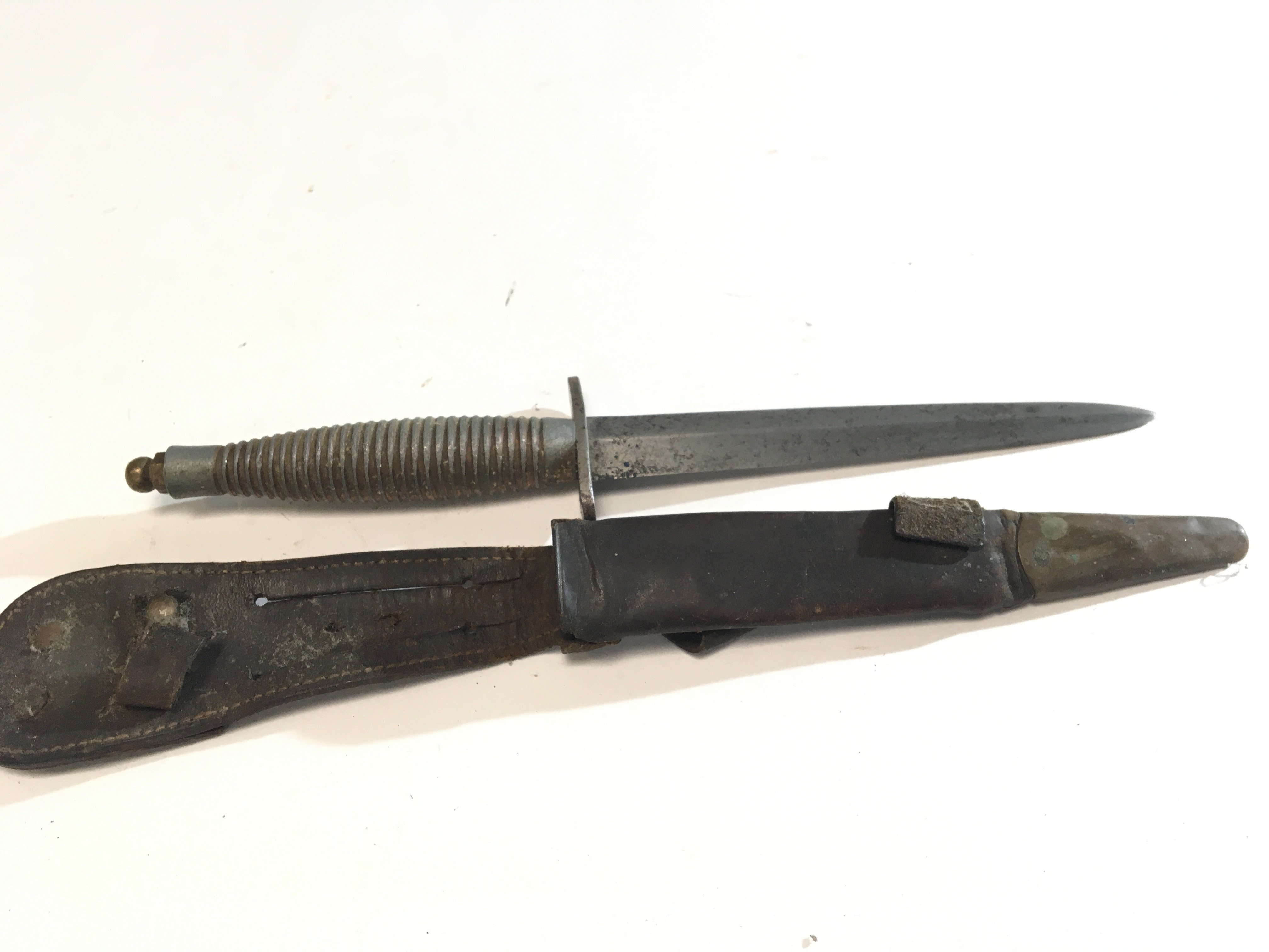 A Fairbrain Sykes commando Knife possible II world war issue and Third pattern with a ribbed grip the cross guard top edge impressed England.