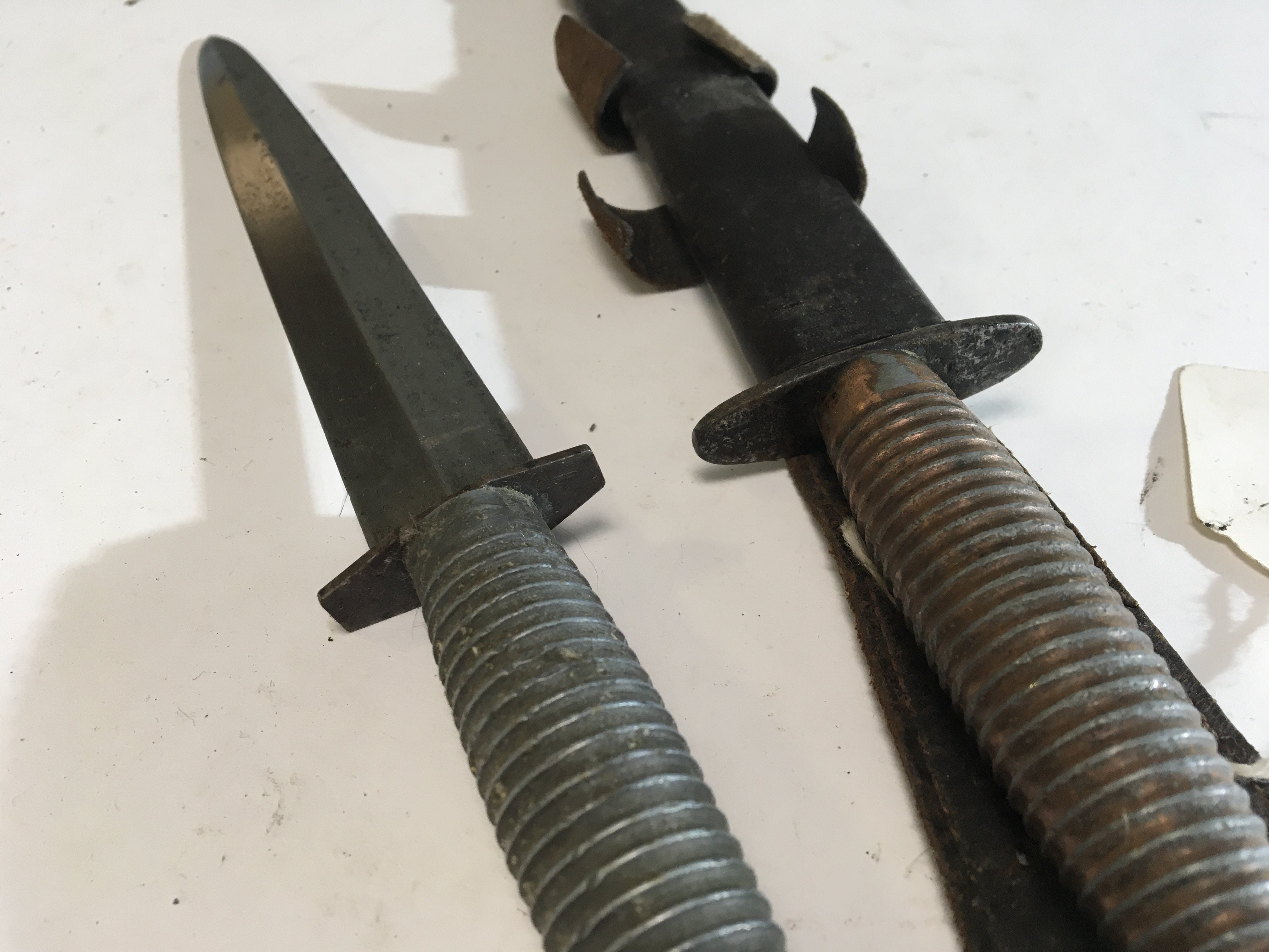 A Fairbrain Sykes Commando fighting knife and one other possible II world war issue Third pattern one with obscure marks to the cross guard. (2)