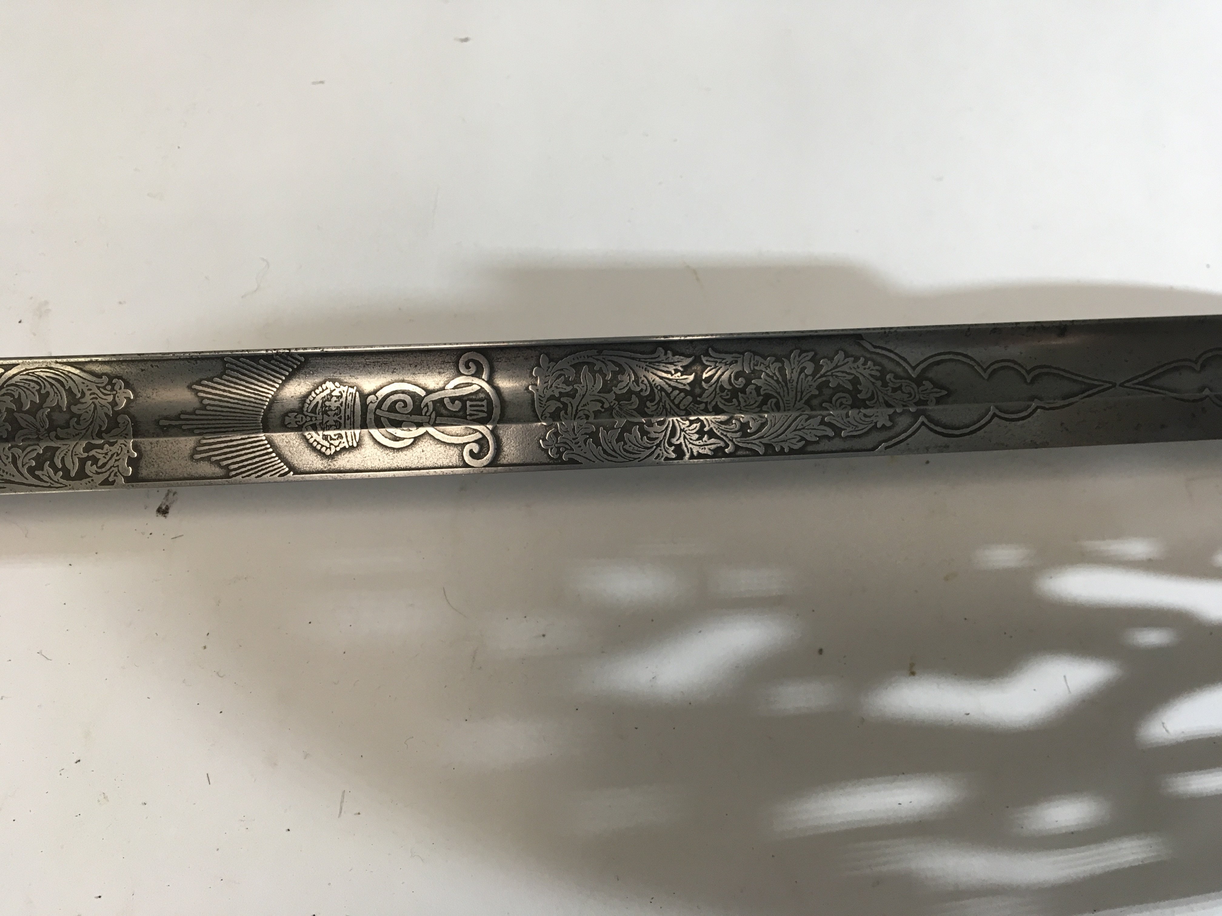 An interesting Edward VII Military sword with engraved blade and edge Military numbered 16164 possible made in Germany for the British Army.