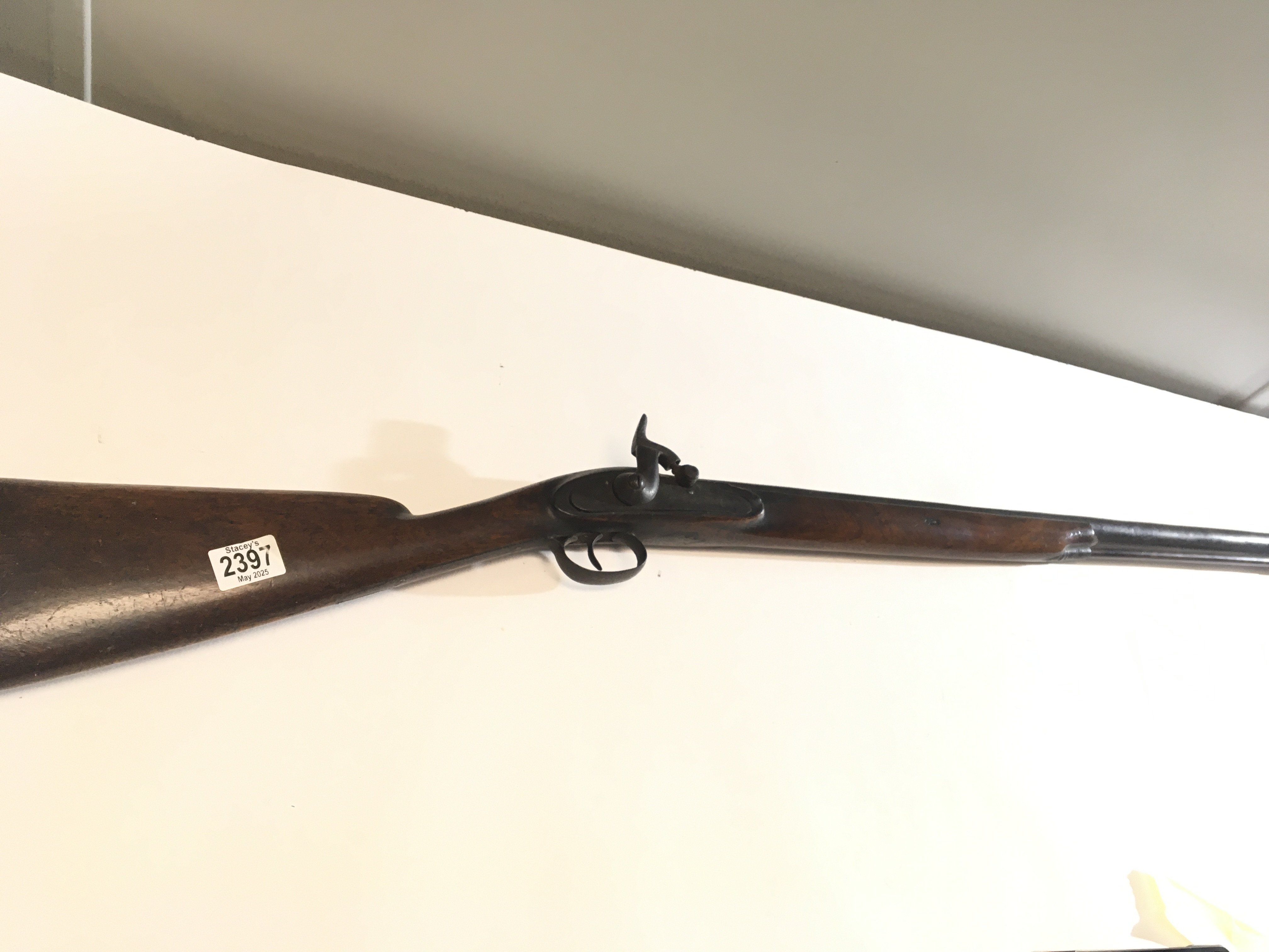 A 19th century Percussion Rifle with half length walnut stock long barrel with ram rod no maker marks. functional action